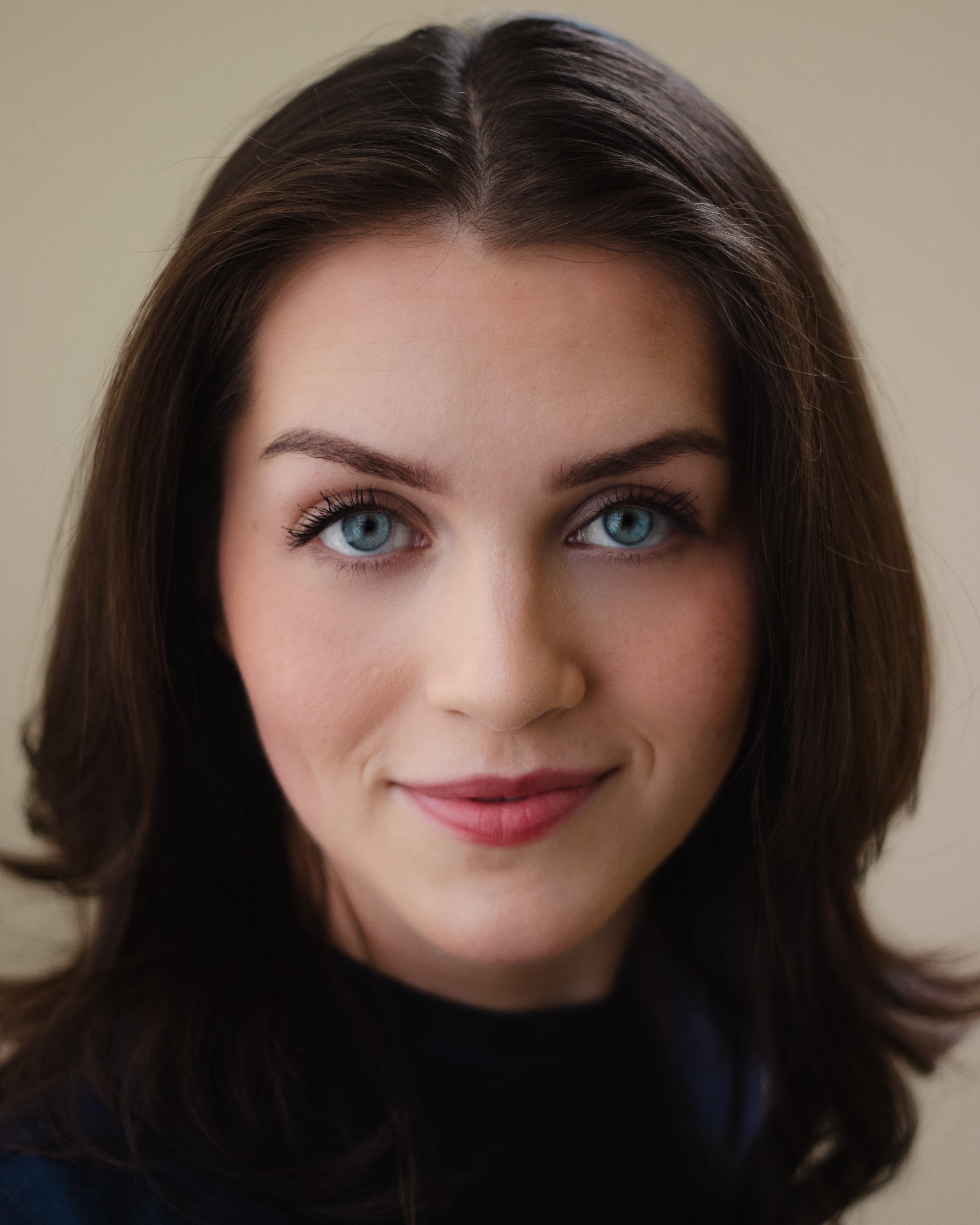 Carmina Monserrat headshot with yellow background