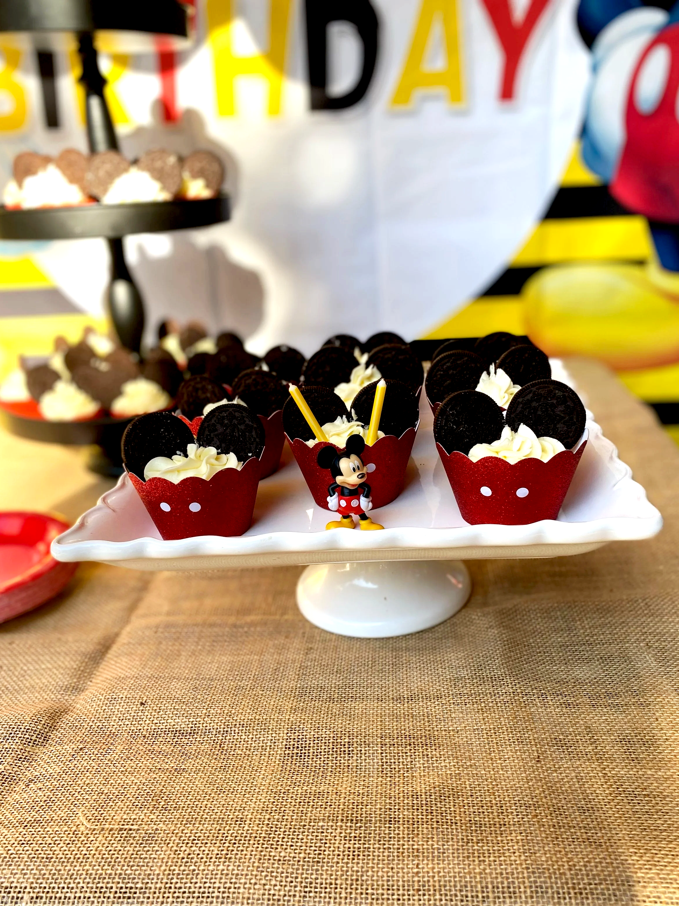 Minnie Mouse themed cupcake stand with chocolate and vanilla cupcakes decorated for a birthday party.