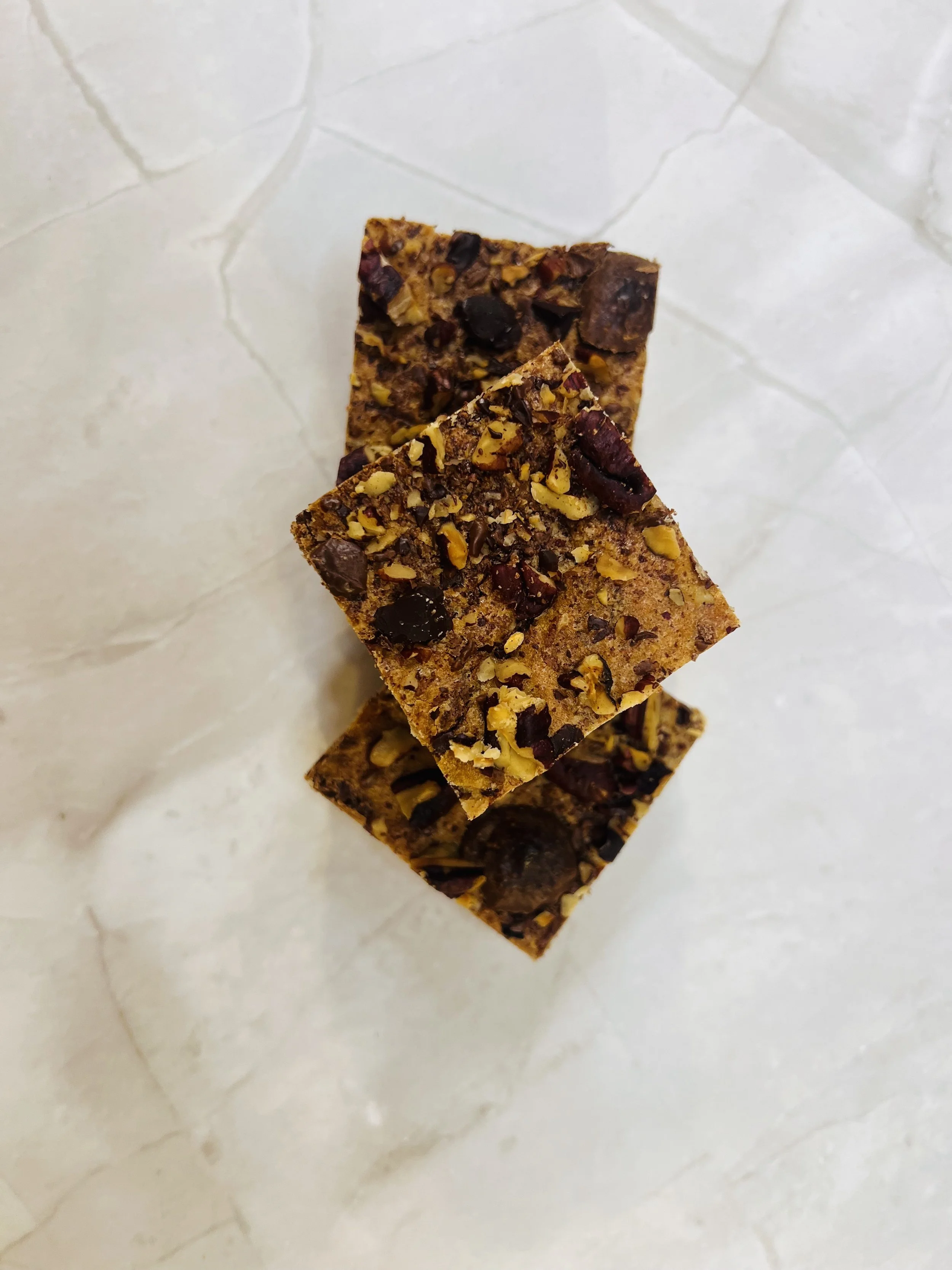 Square desert bar covered in nuts. Links to the bars menu.