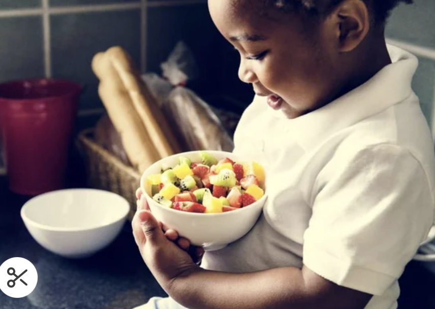 A child eating bowl of healthy food.