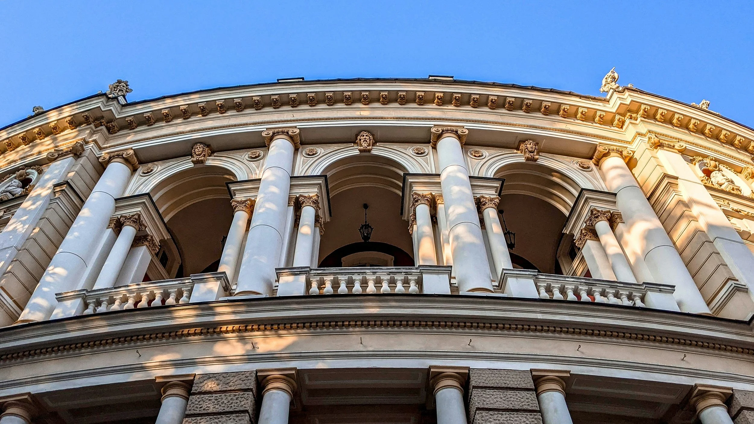 Building featuring architectural elements such as columns, caps, bases, arches, cornices, dentals, keystones, and medallions.