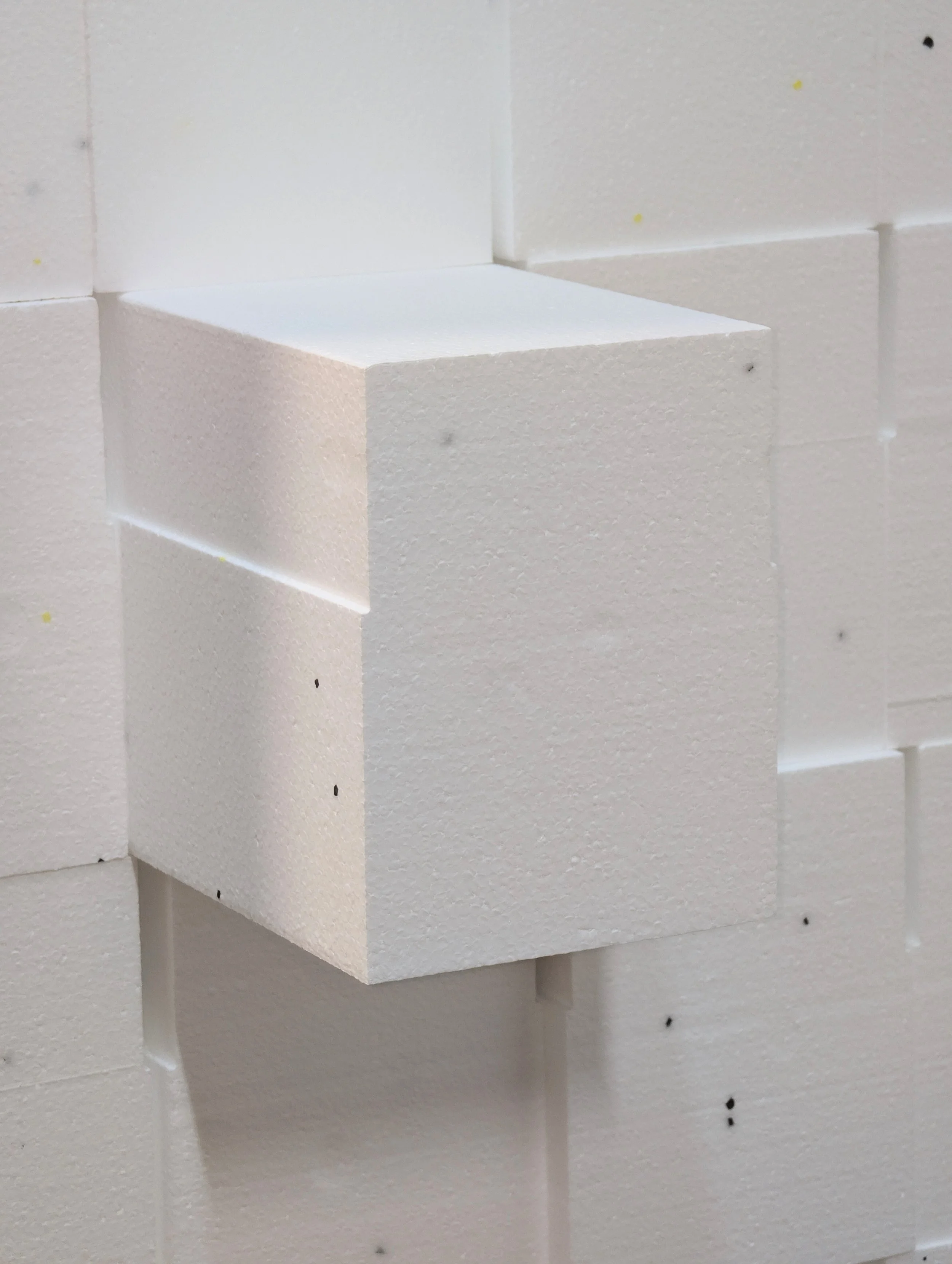 Pile of EIFS Starters cut out of EPS Foam with one poking through