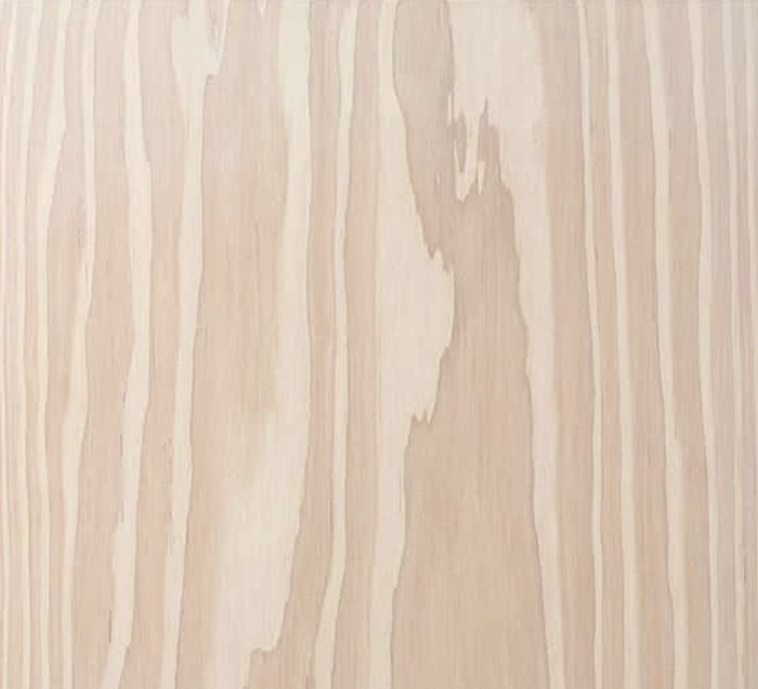 Close-up of a light-colored wooden surface with visible wood grain patterns.