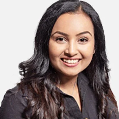 Close-up portrait of a woman with long dark hair smiling, wearing a black top.