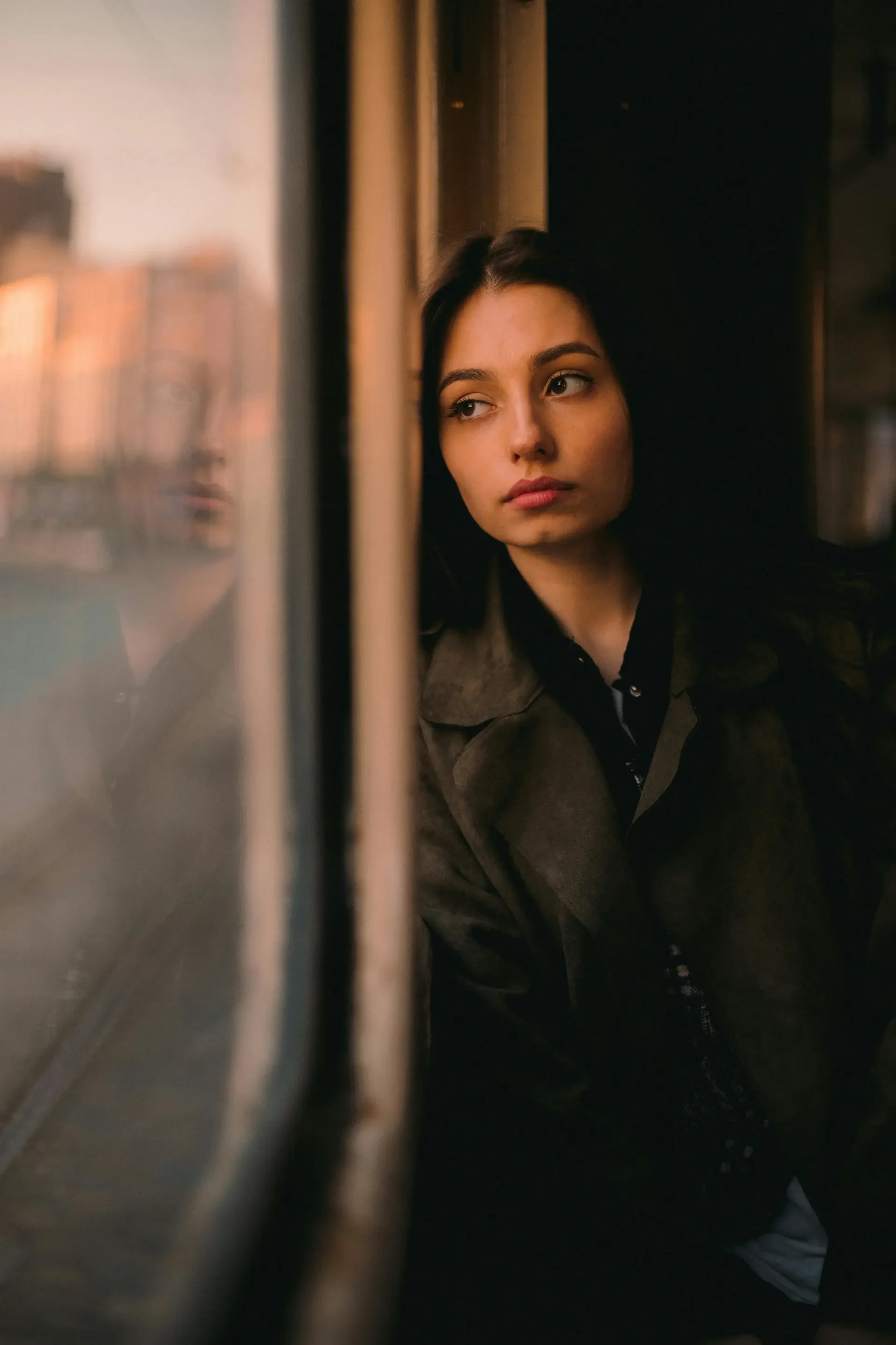 A person looking out a window in quiet reflection during the early stages of adjusting to hypothyroidism.