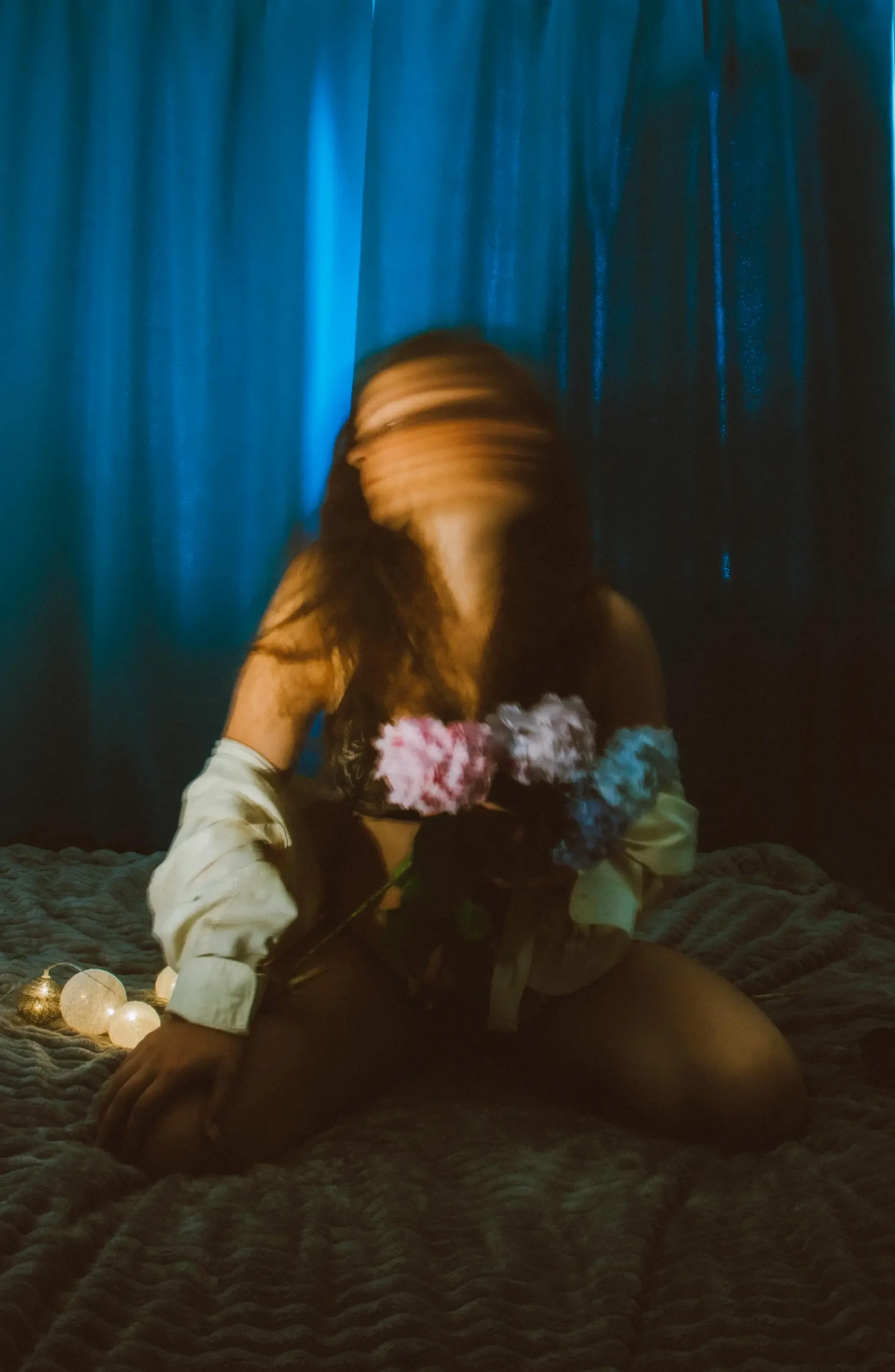 Moody artistic portrait of a modern woman holding flowers, symbolizing emotional depth, comparison pressure, and feeling misunderstood in today’s world