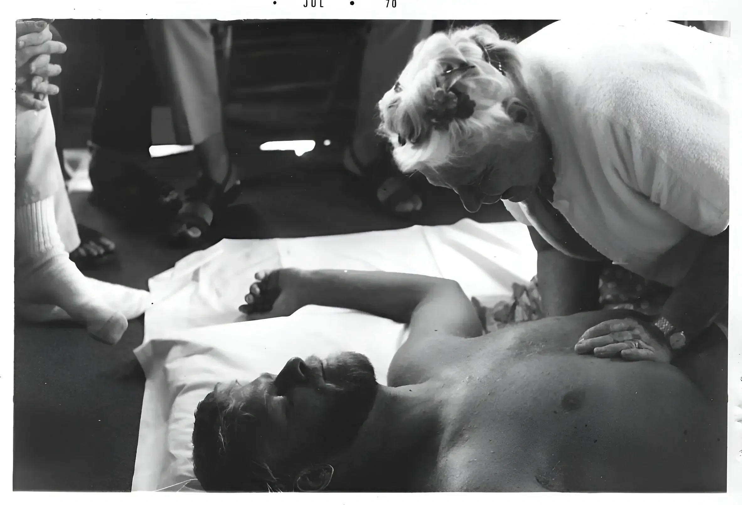 Dr. Ida Rolf the woman who invented Rolfing, is working on a man laying down. this image belongs to Rolfing Boston the blog.