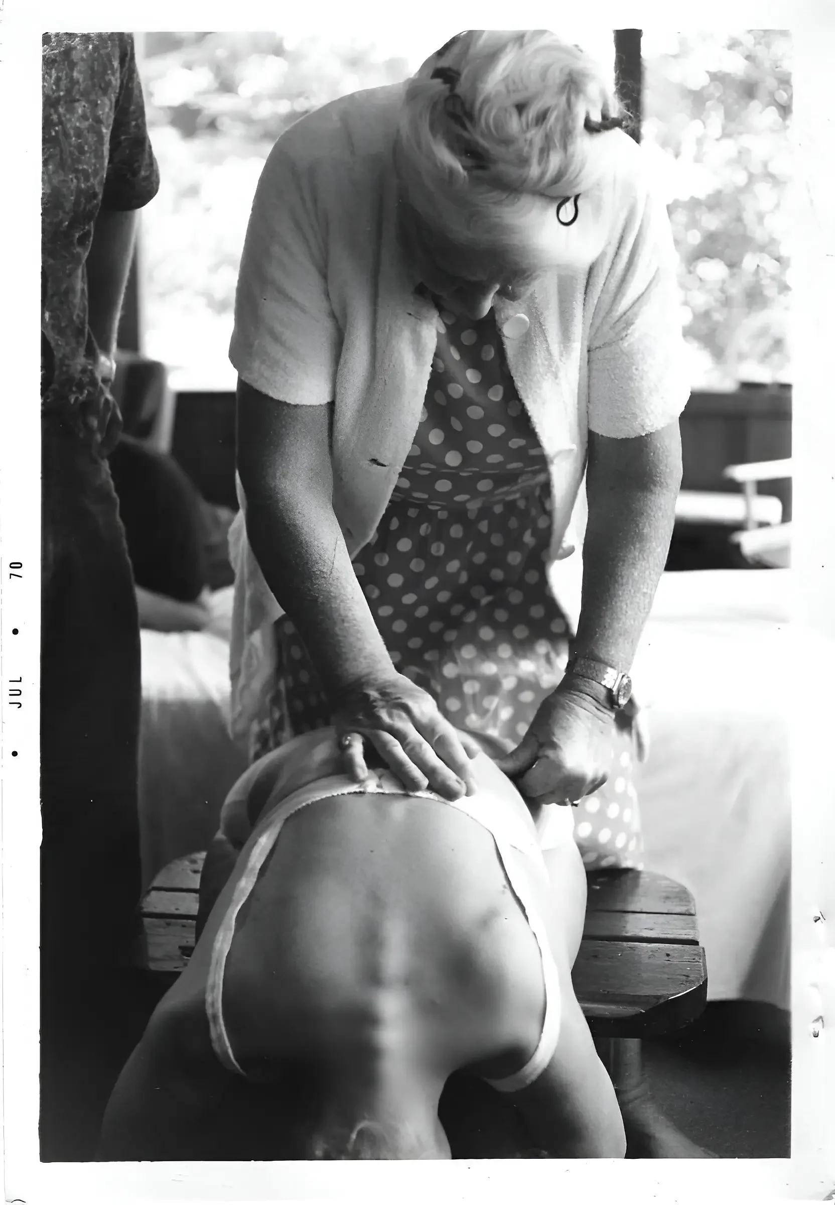 Dr. Ida Rolf, the progenetor of Rolfing, giving a session to a woman in a seated position. and image related to Rolfing Boston the blog