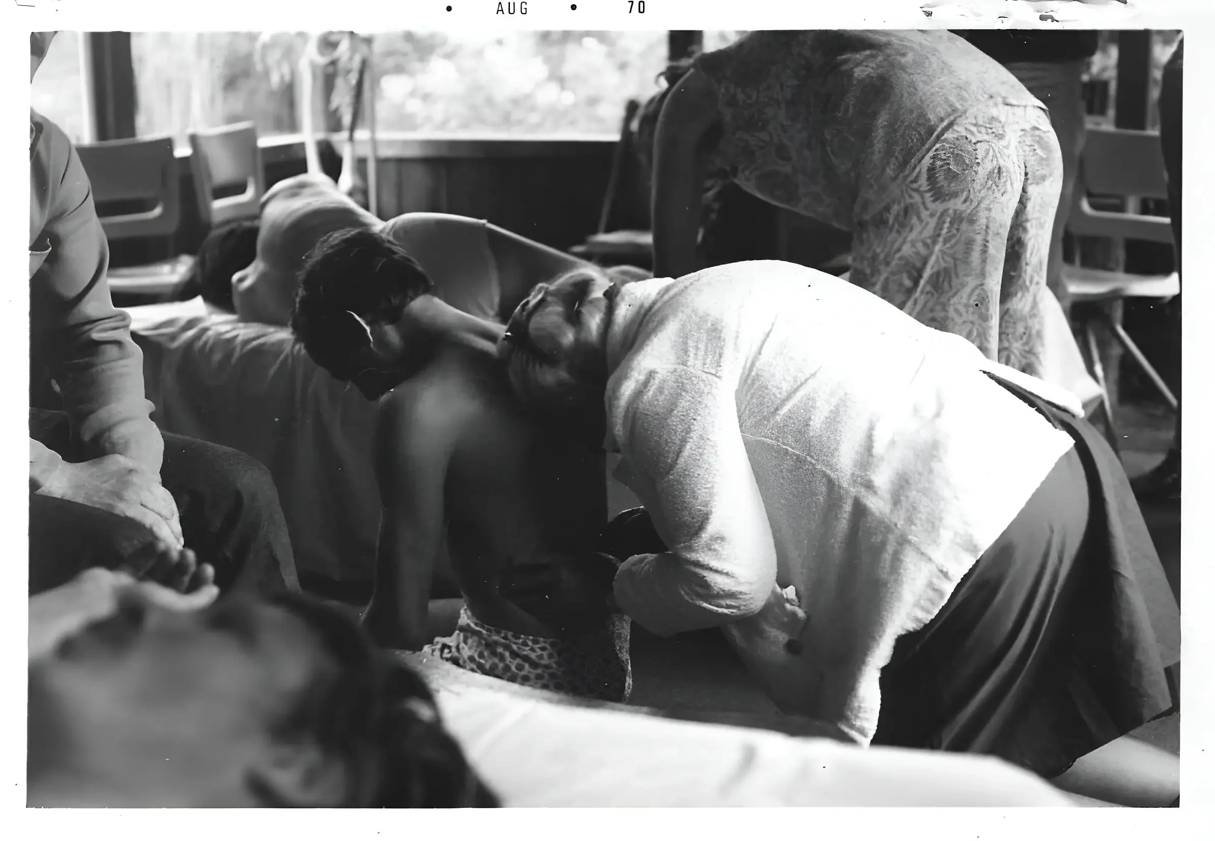 Dr. Ida Rolf, the creator of Rolfing, Rolfing another person sitting down. An image related to Rolfing Boston the blog