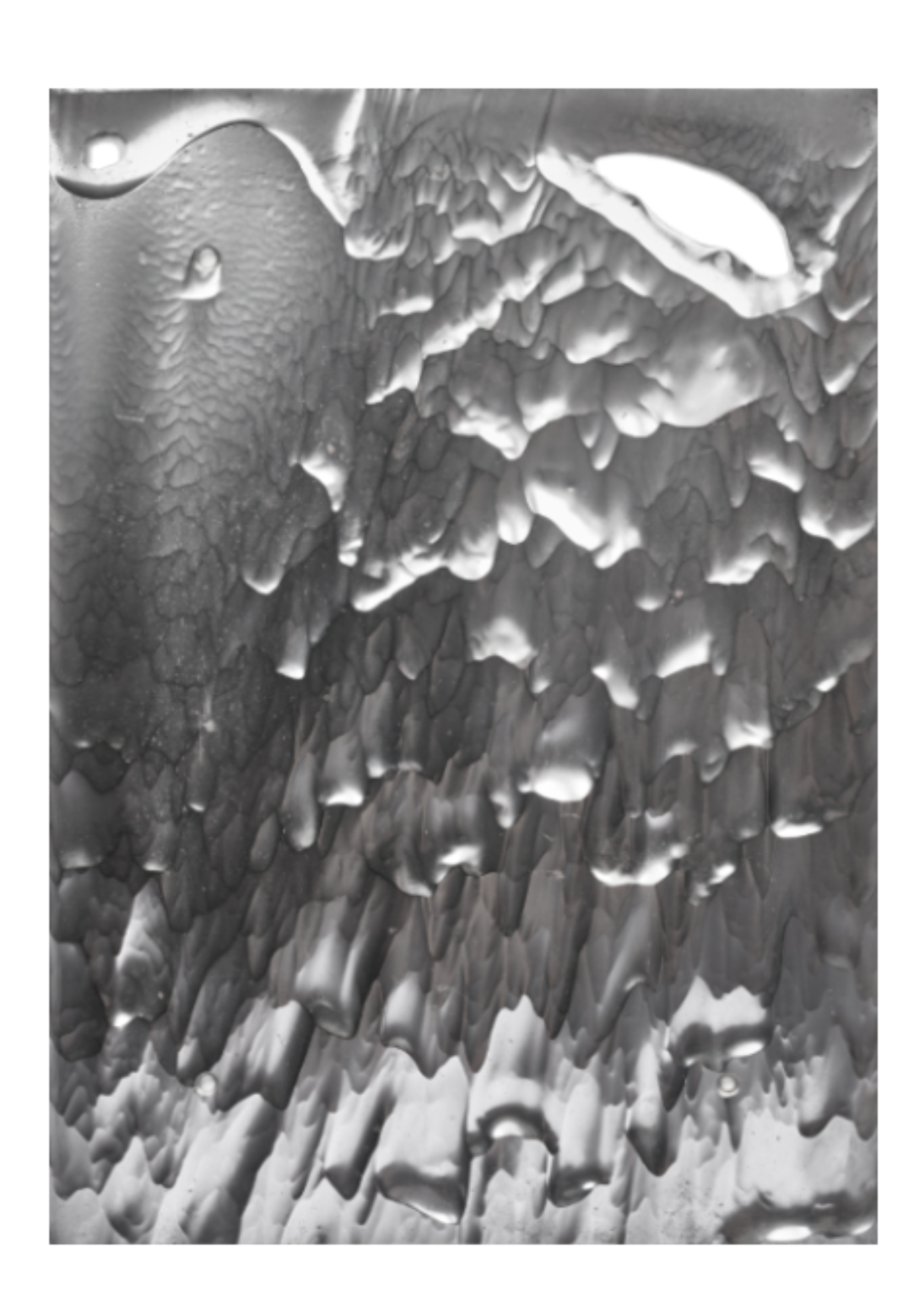 Close-up of ice crystals or frost forming jagged, irregular patterns, appearing translucent and layered.