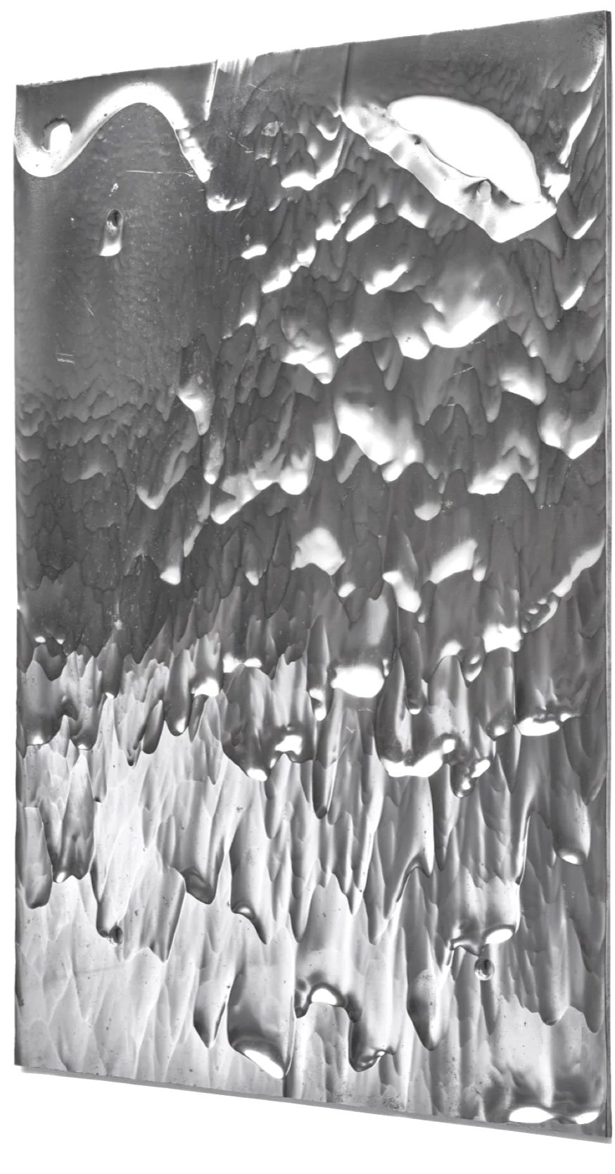 Close-up of a metallic surface with irregular, jagged textures and scratches.