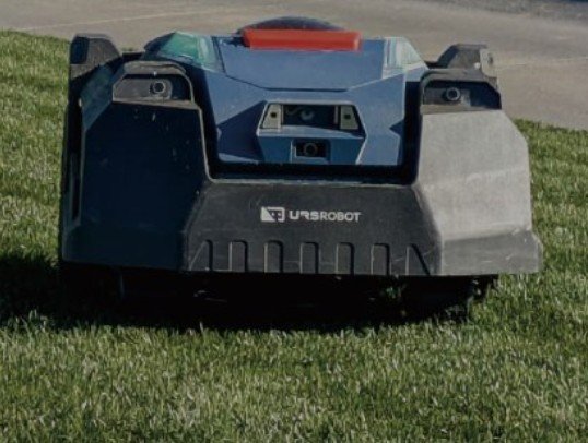 A robotic lawn mower on a grassy lawn.