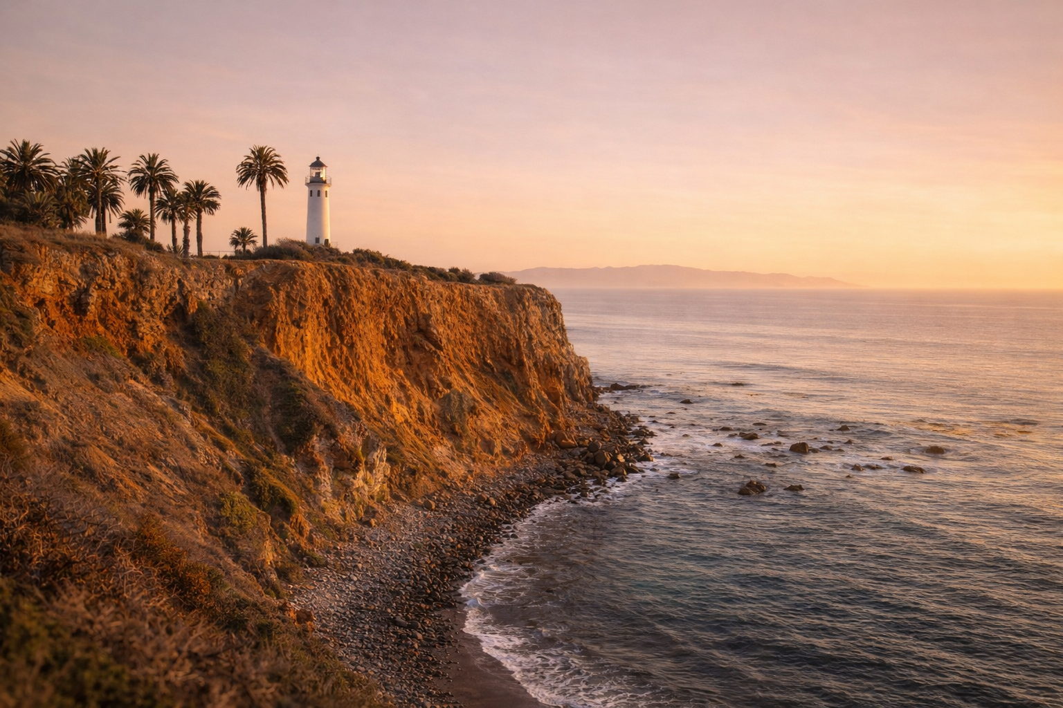 Lighthouse on a coastal cliff overlooking the Pacific Ocean in Palos Verdes, South Bay, showcasing the scenic beauty and luxury coastal homes represented by Pinar Kara Real Estate.