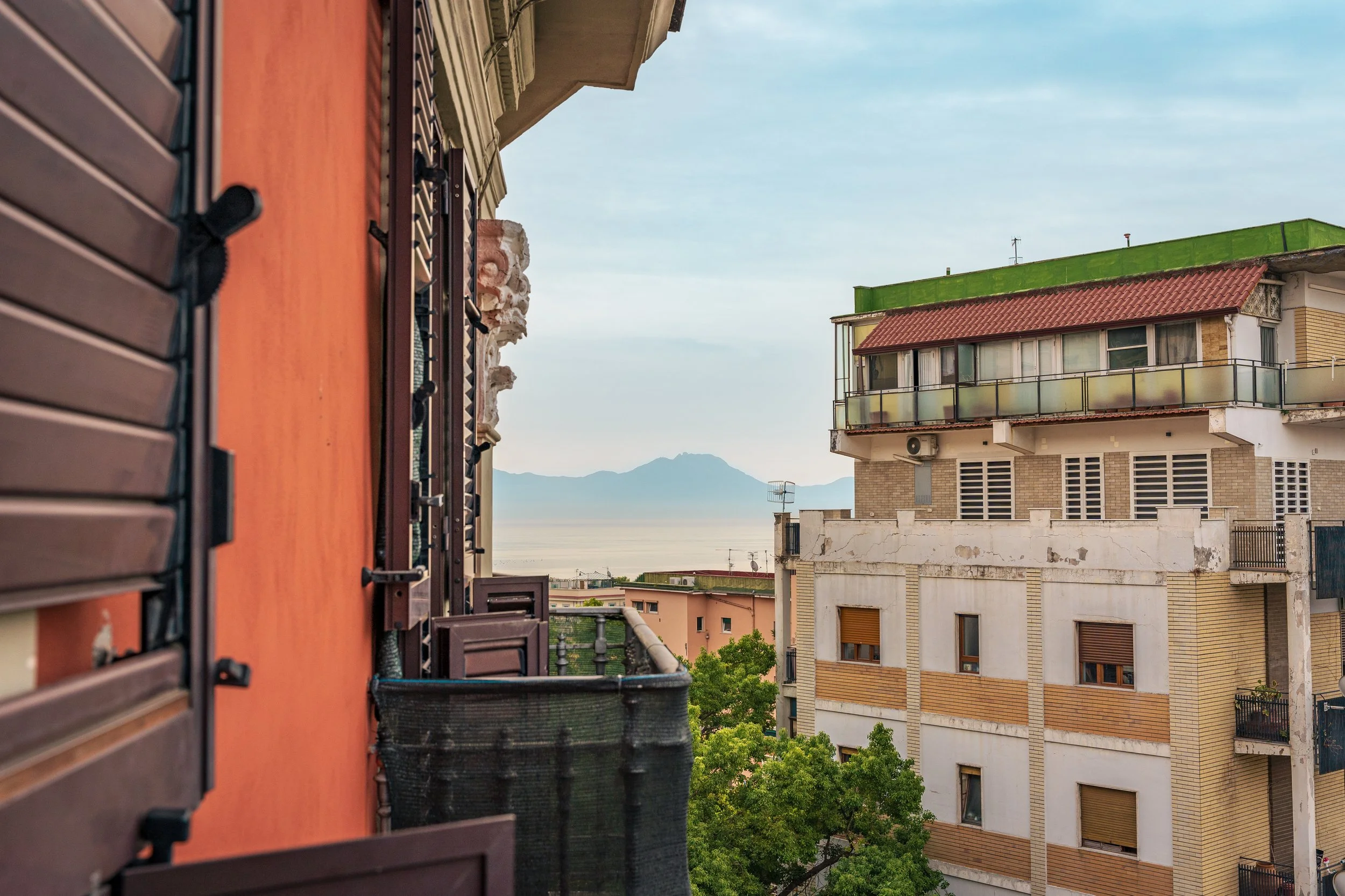 A small view of (possibly) Mount Vesuvius and the Mediterranean Sea in Chiaia, Naples, Italy.