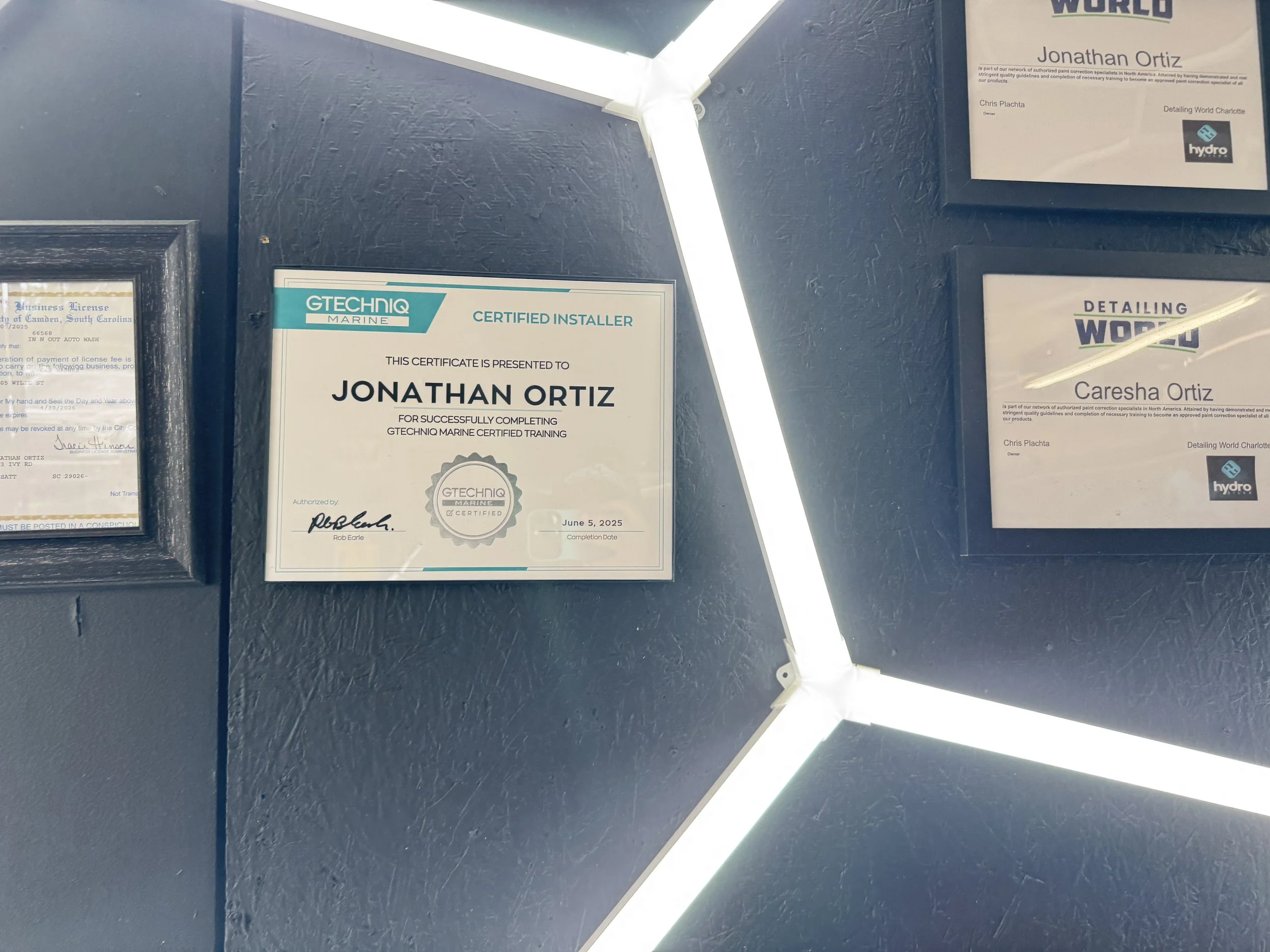 Certificate awarded to Jonathan Ortiz for completing GTECHNIC Marine certified training, dated June 5, 2025, displayed on a dark wall with framed certificates and illuminated by white light.
