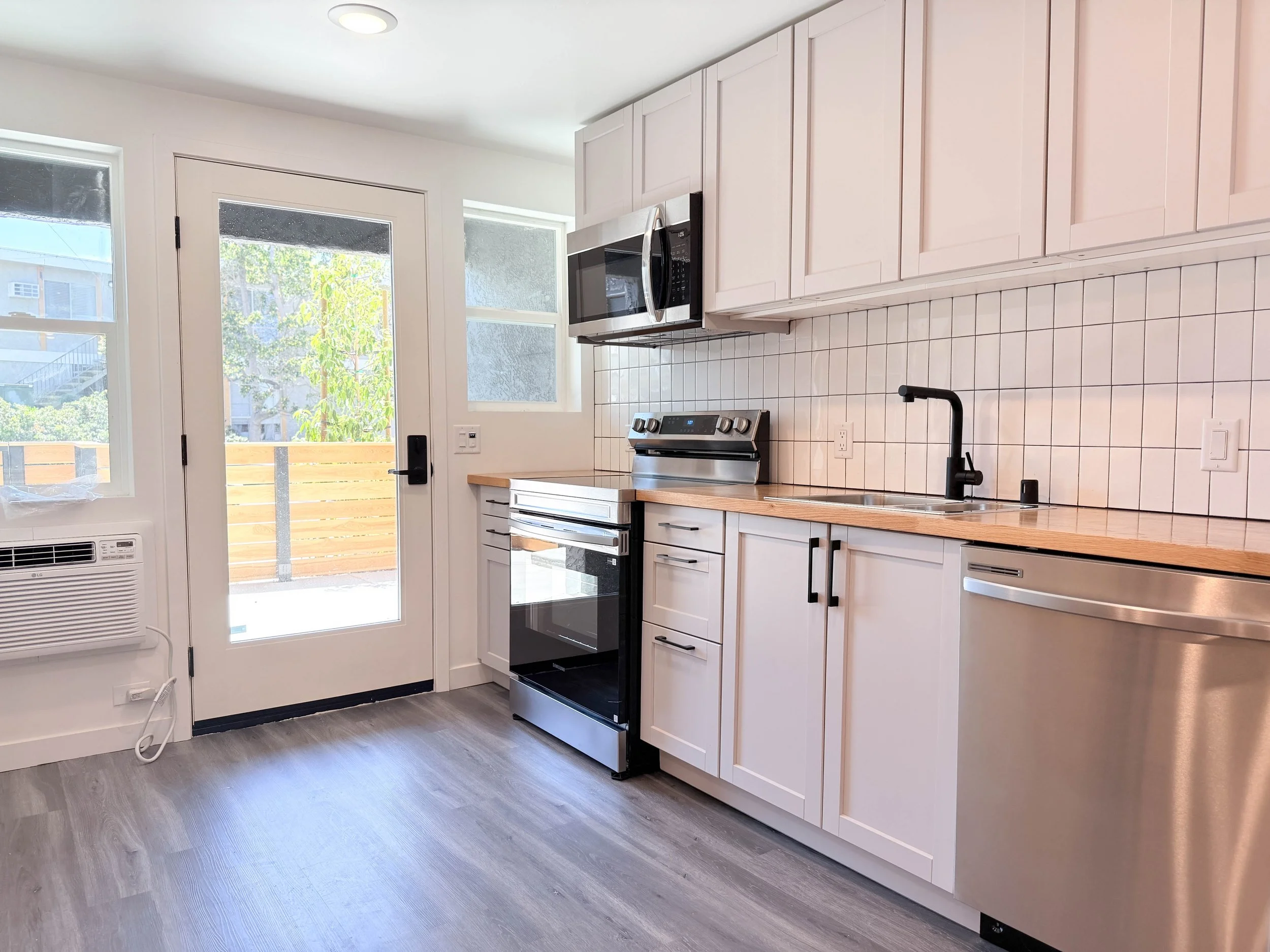 Floor plan of a small apartment with a living area, kitchen, bathroom, and bedroom with a balcony.