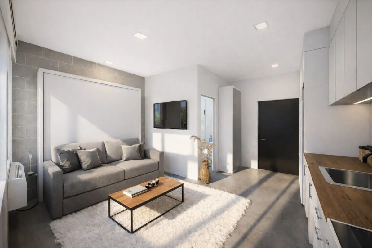 Floor plan of a small apartment with a bedroom, bathroom, kitchen, and balcony with two chairs and a small table.