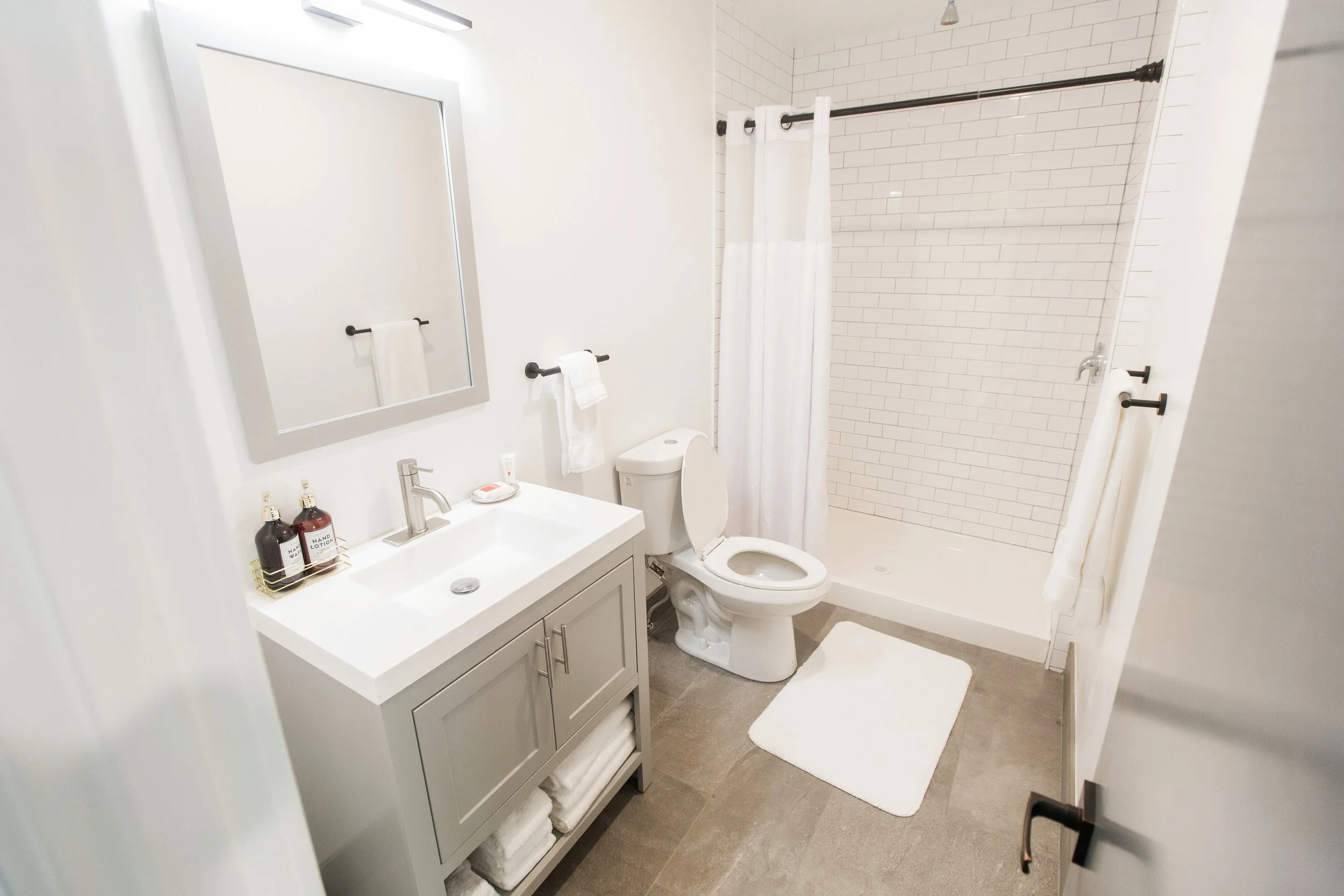 Floor plan of a small apartment including a living room, kitchen area, bedroom, and bathroom with shower.