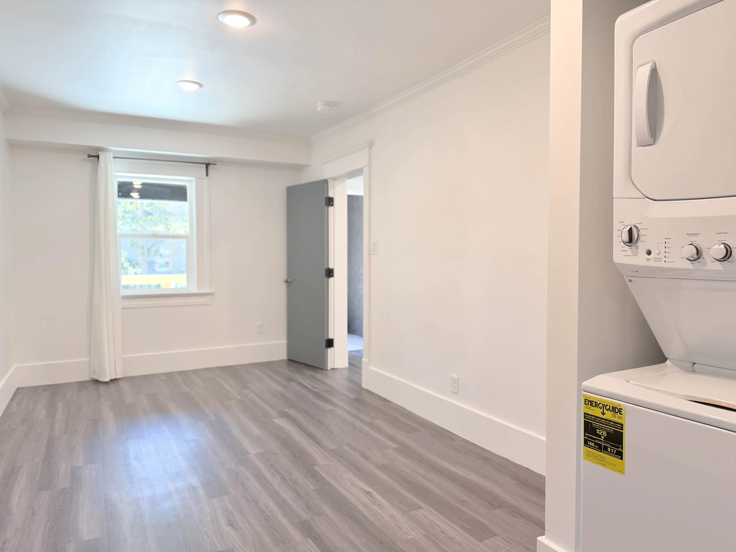 Floor plan of a small apartment including a living room, kitchen area, bedroom, and bathroom with shower.