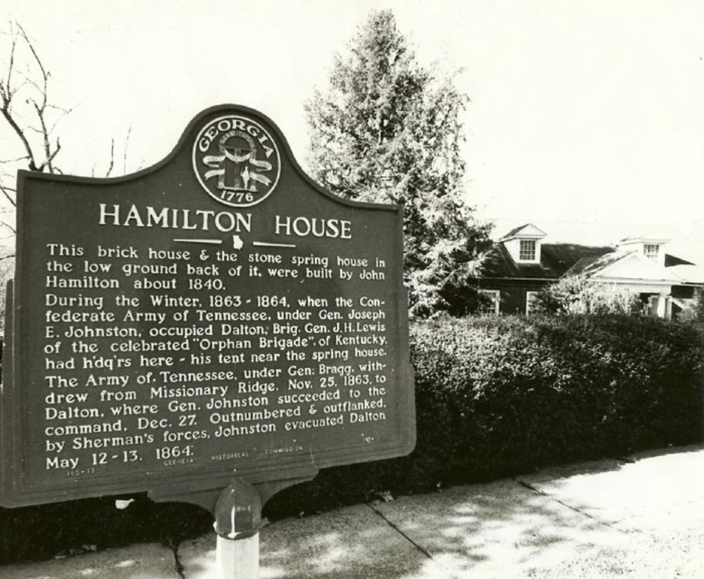 Historical marker sign in front of the Hamilton House, built around 1840, in Georgia, describing its history including involvement during the American Civil War and its association with John Hamilton.