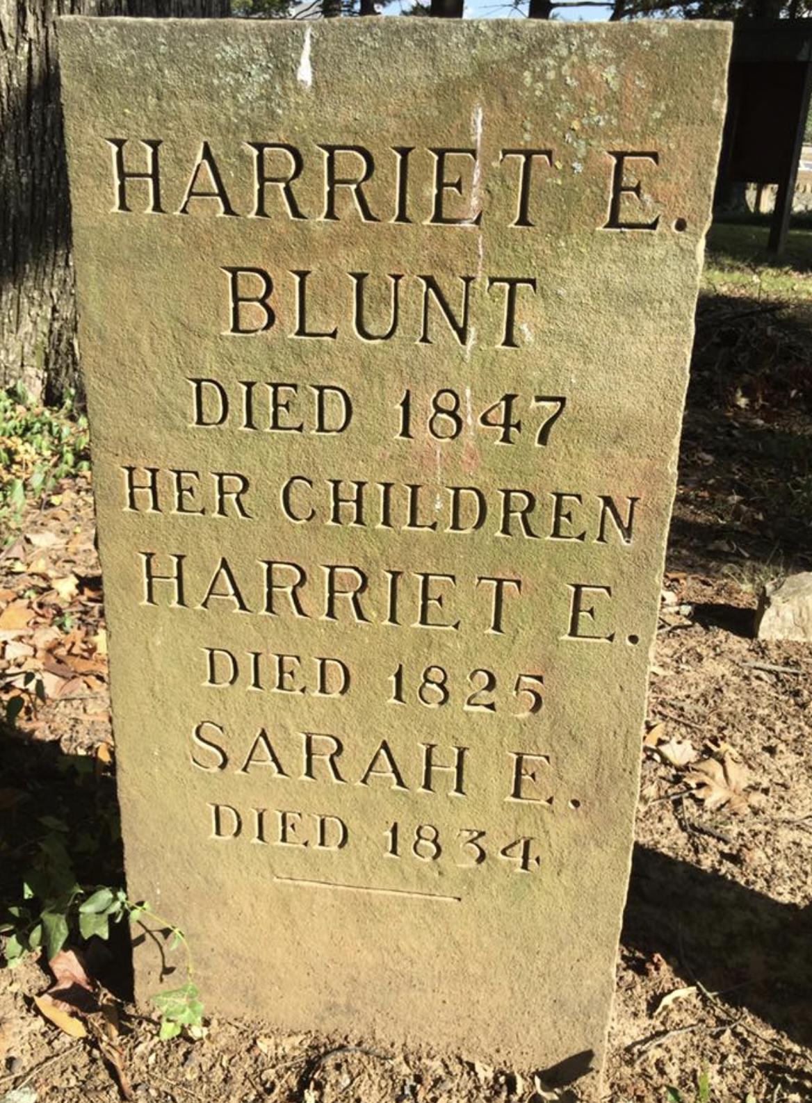 A carved stone memorial tablet honoring Harriet E. Blunt, who died in 1847, and her children Harriet E. who died in 1825, and Sarah E. who died in 1834.