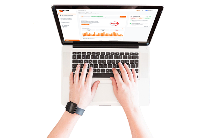 Person using a laptop with a stock trading or financial analytics dashboard displayed on the screen.