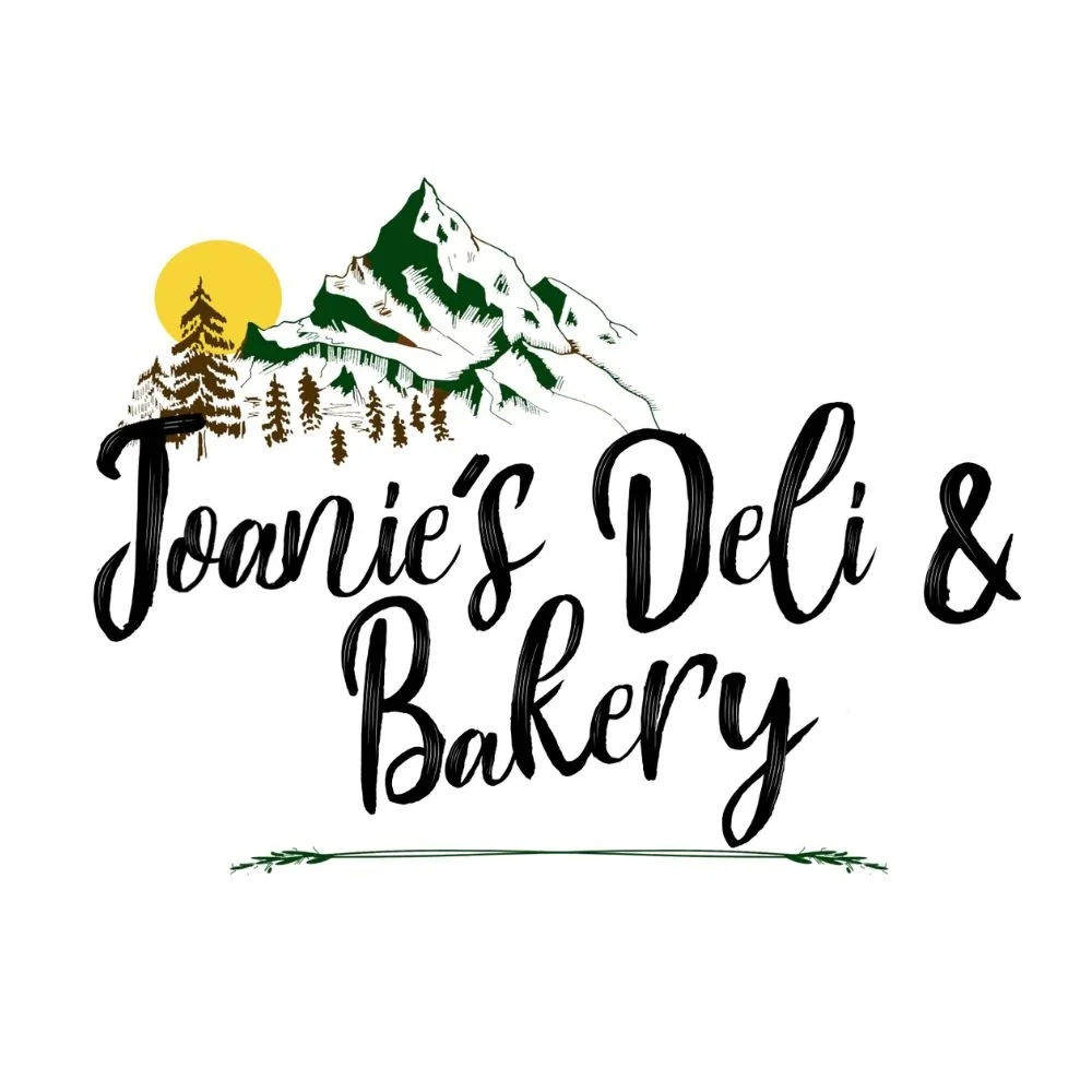 Logo for Toanie's Deli & Bakery featuring a mountain scene with pine trees and a sun.