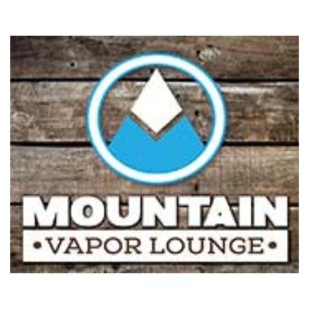 Logo for Mountain Vapor Lounge featuring a mountain icon with a white and blue color scheme, set against a wooden background.