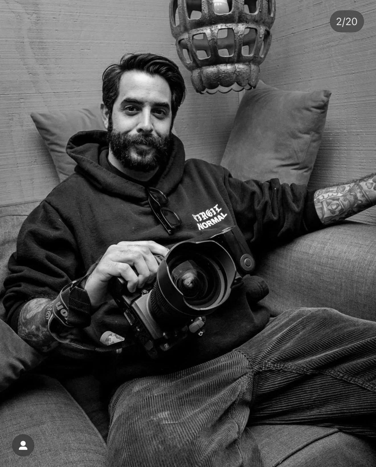 man sitting on a couch with a camera