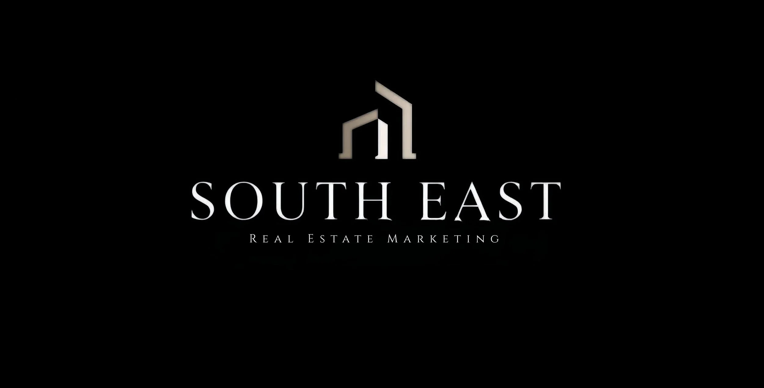 South East Real Estate Marketing logo with a stylized building icon in gray and white on a black background.