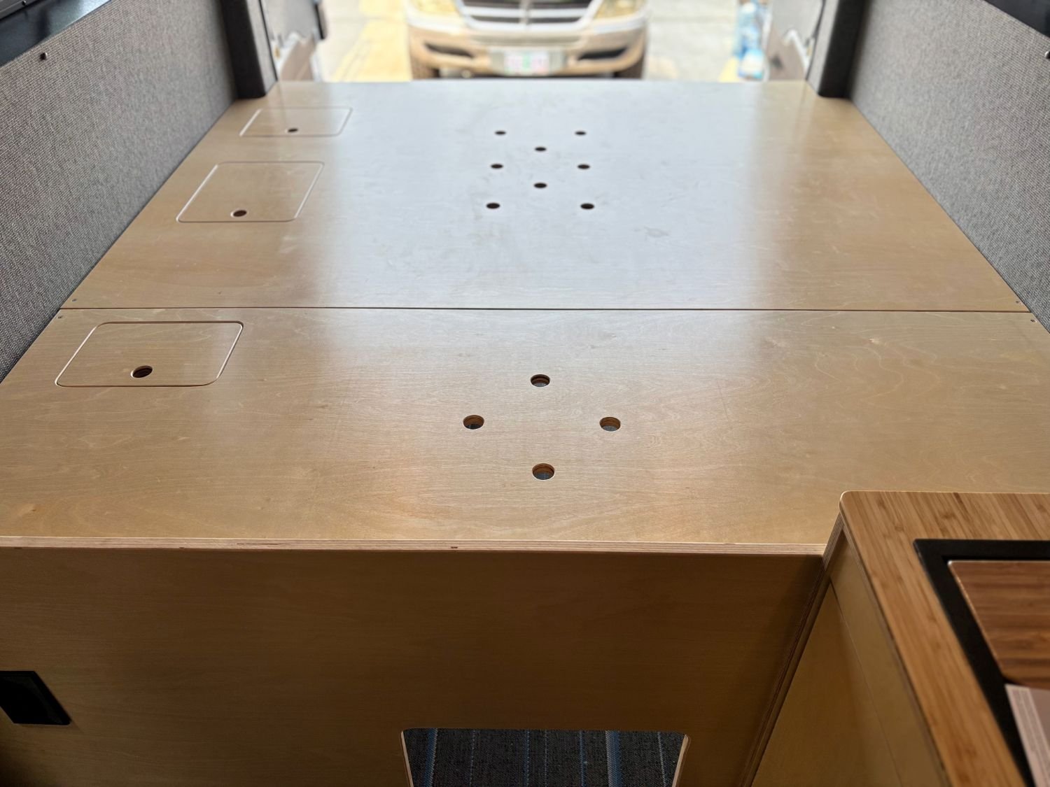 Custom built camper van bed platform with storage