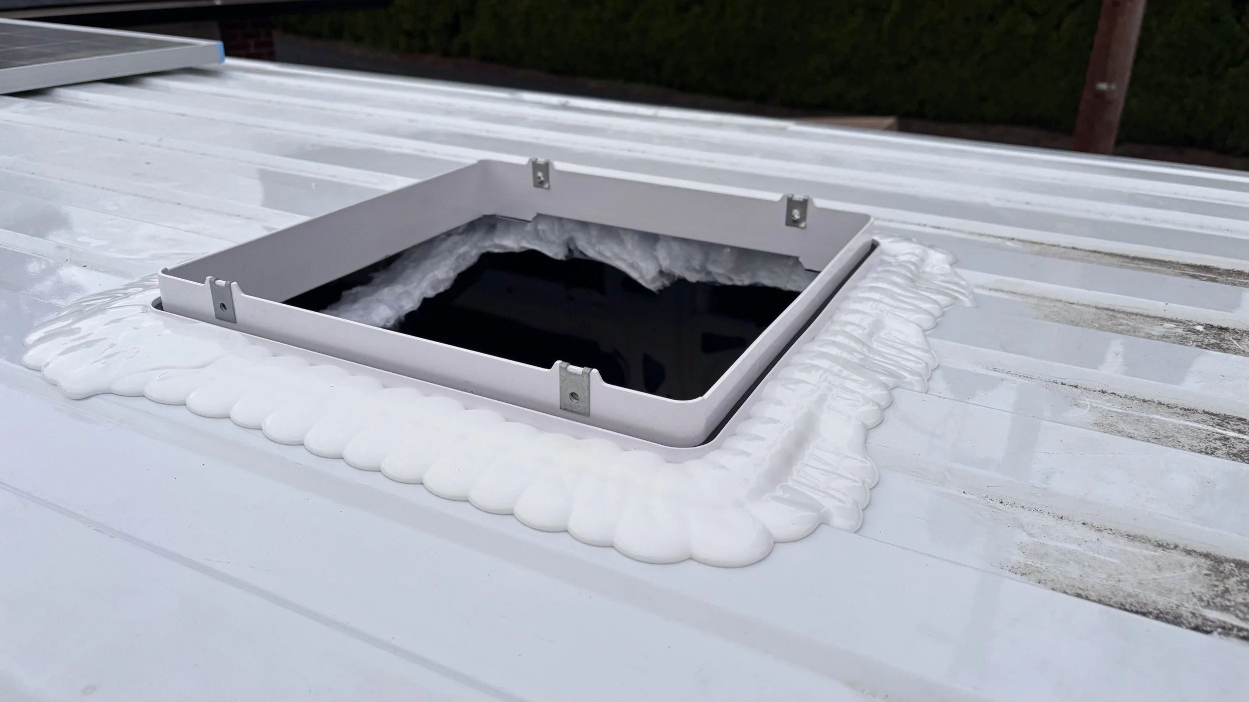 Professional sealing job of a roof top vent on a cargo van RV.