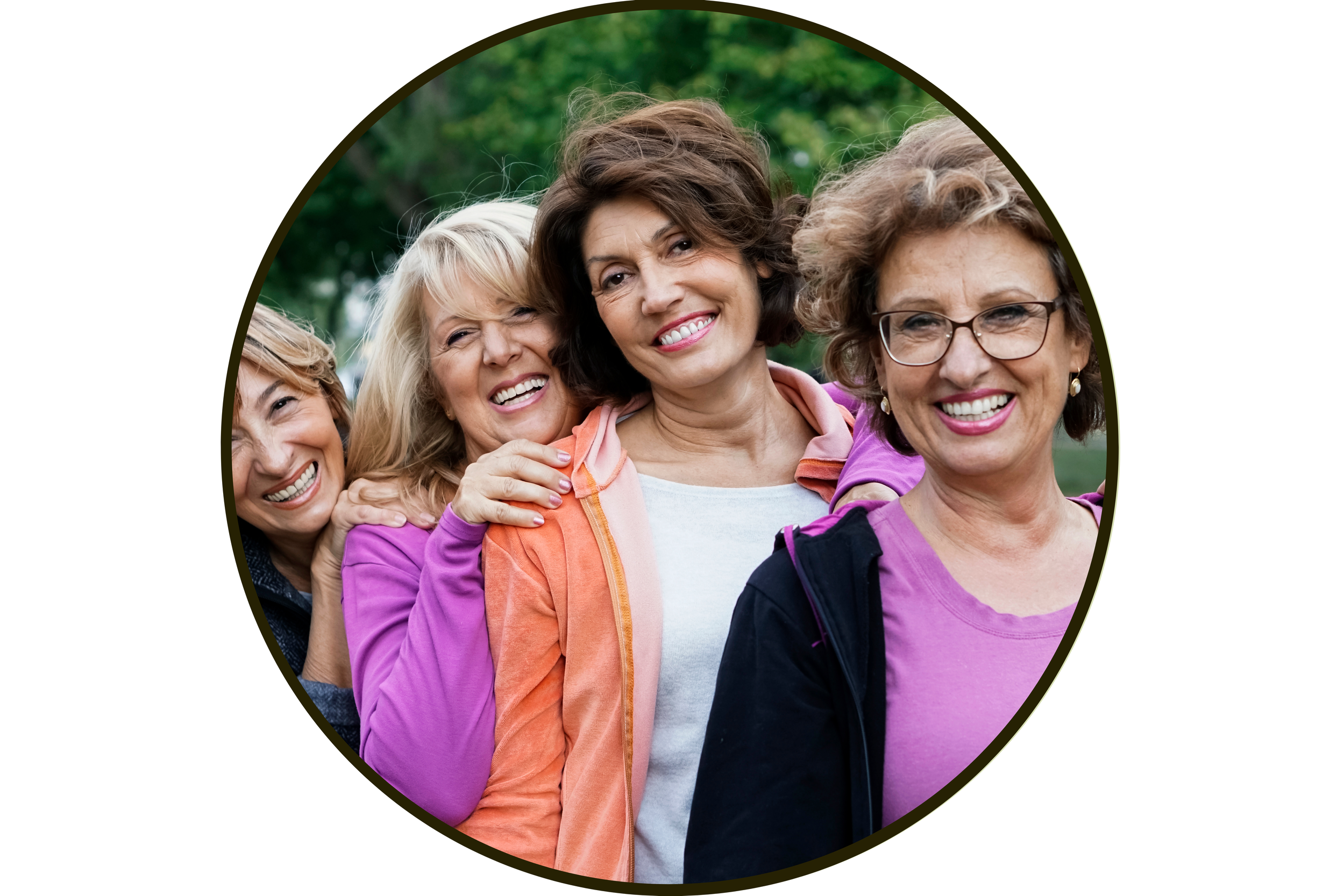 Group of four middle-aged women smiling and posing outdoors in a park.