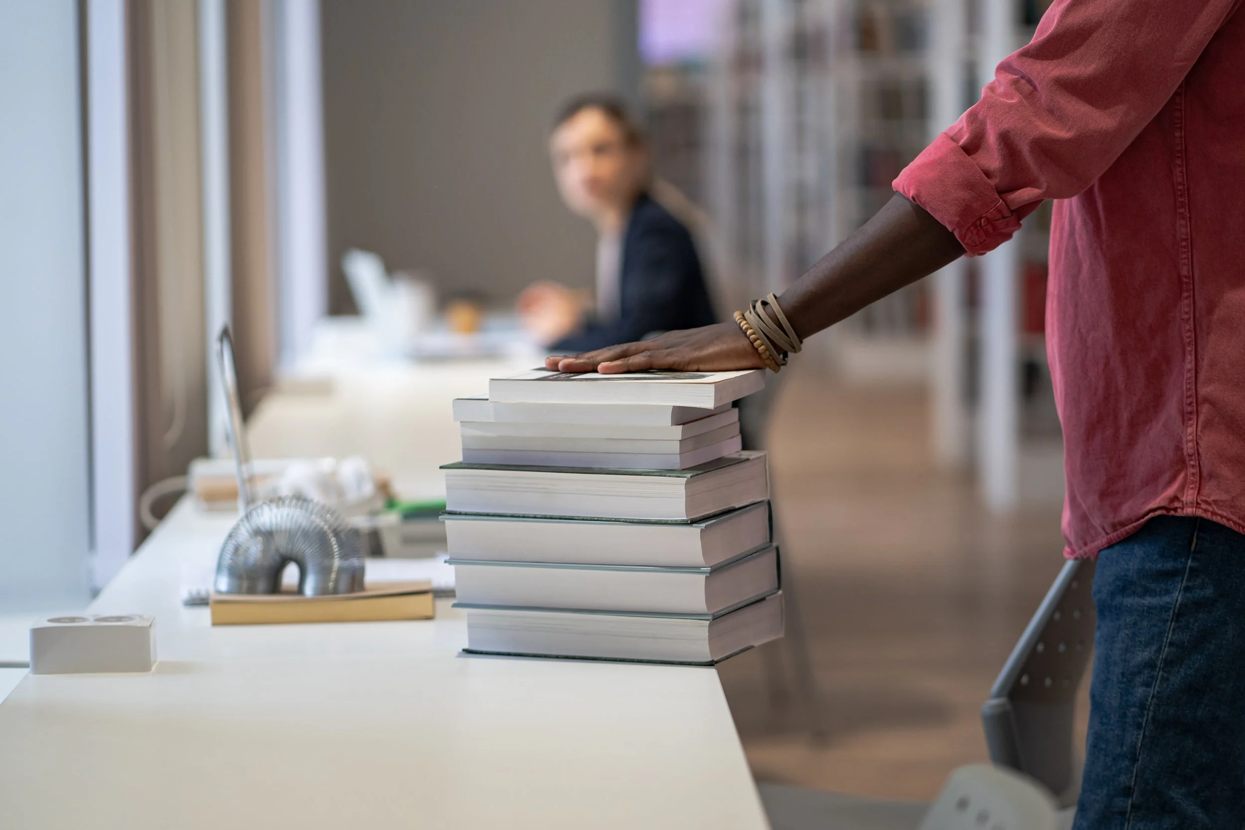 Hand on top of published books