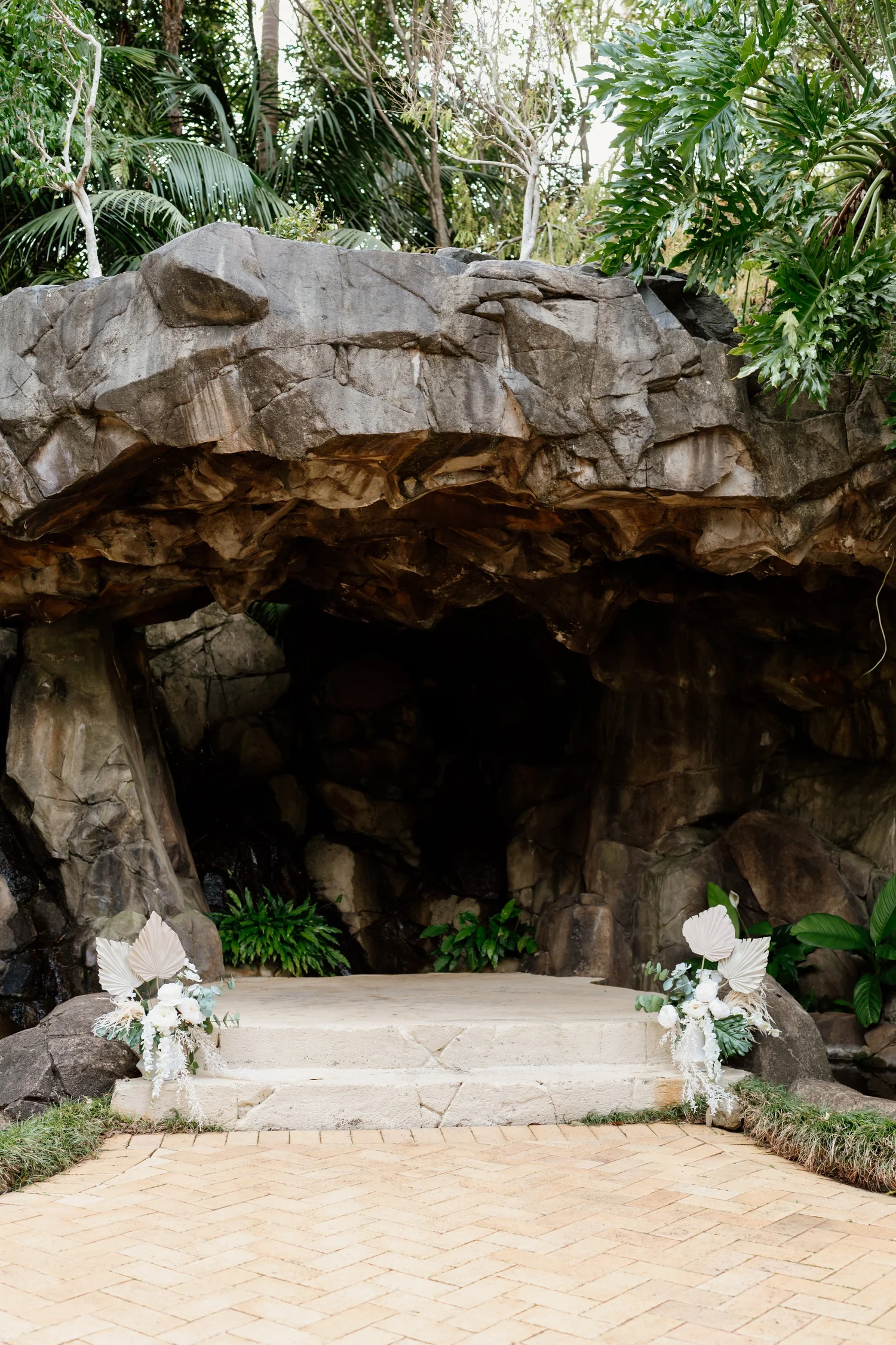 The Waterfall Grotto at Shambala Estate surrounded by tropical garden foliage.