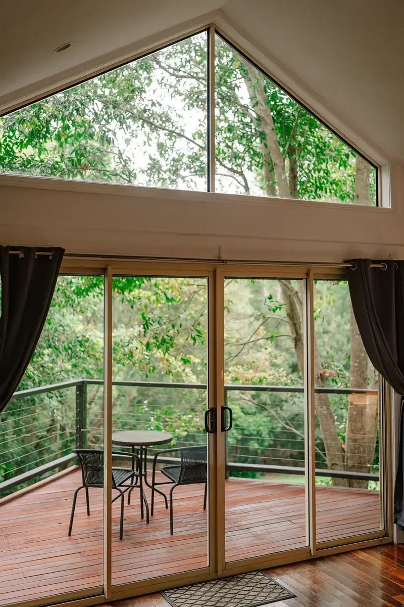 Interior of a Shambala Estate cottage opening onto a private garden balcony.