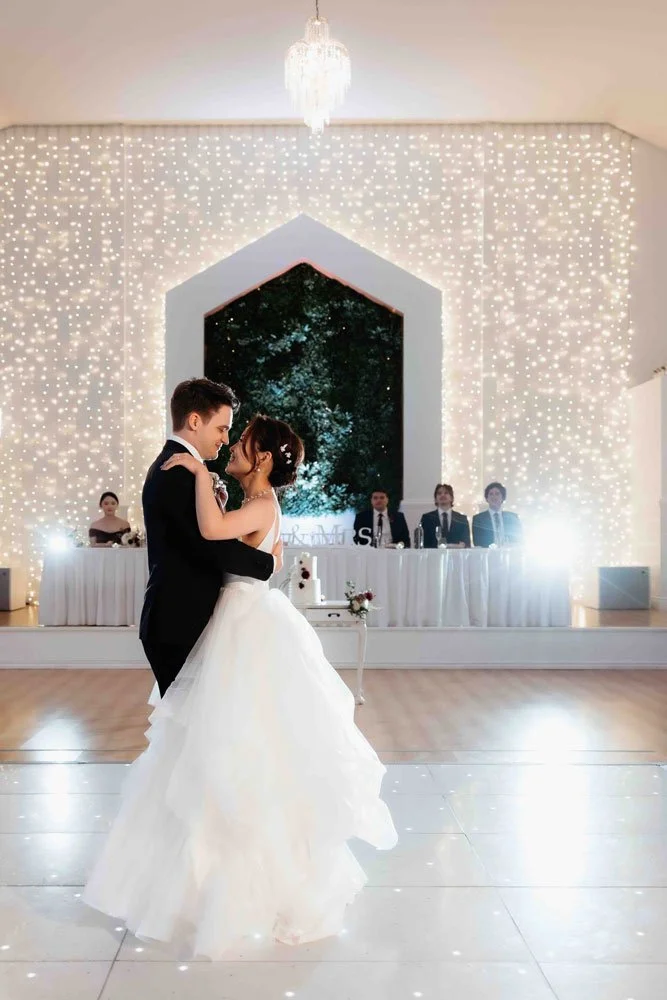 Bride and groom sharing their first dance during a wedding reception at Shambala Estate.