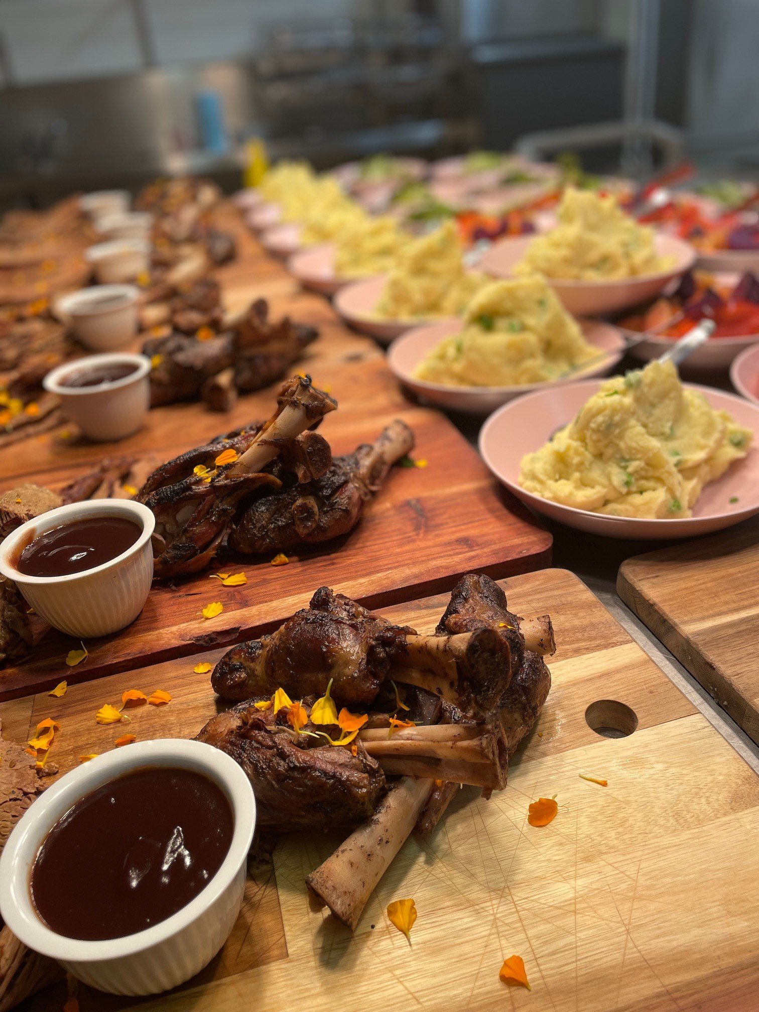 Shared food boards with meat, salad and sauces prepared for wedding dining