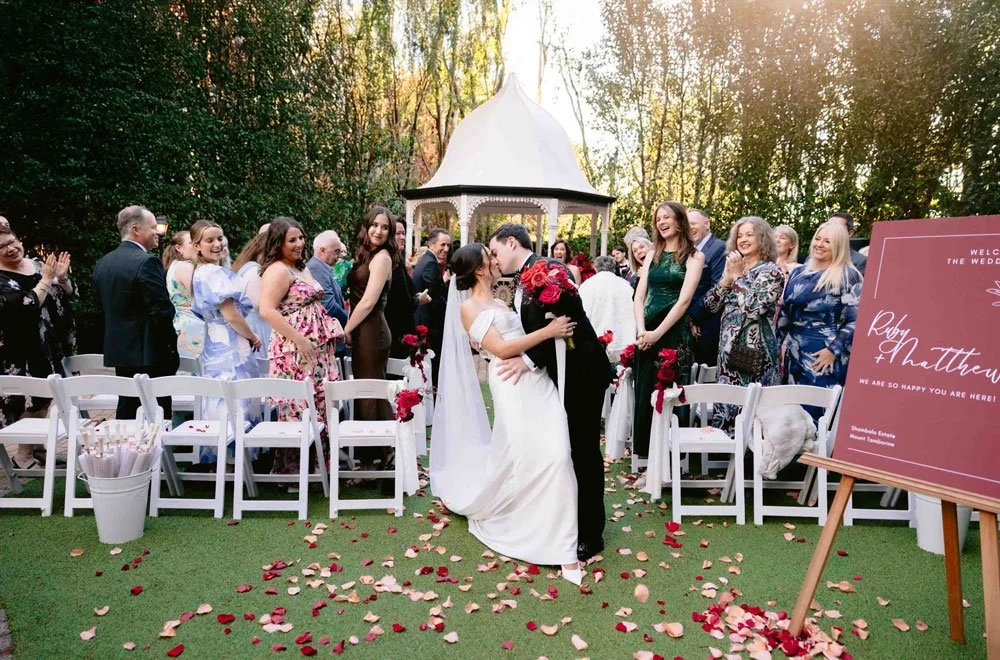 Guests gathered for an intimate garden ceremony at the Gazebo at Shambala Estate.