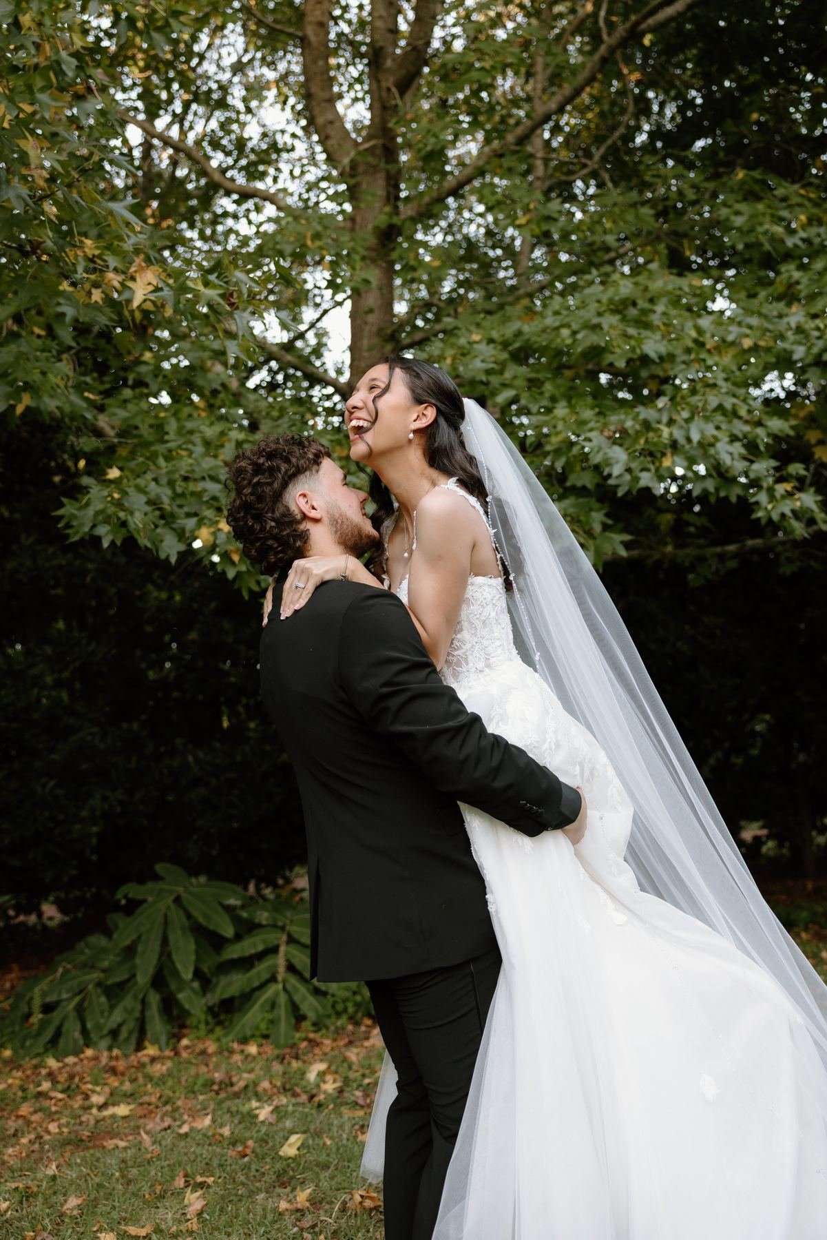 Bride and groom embracing in the gardens at Shambala Estate.
