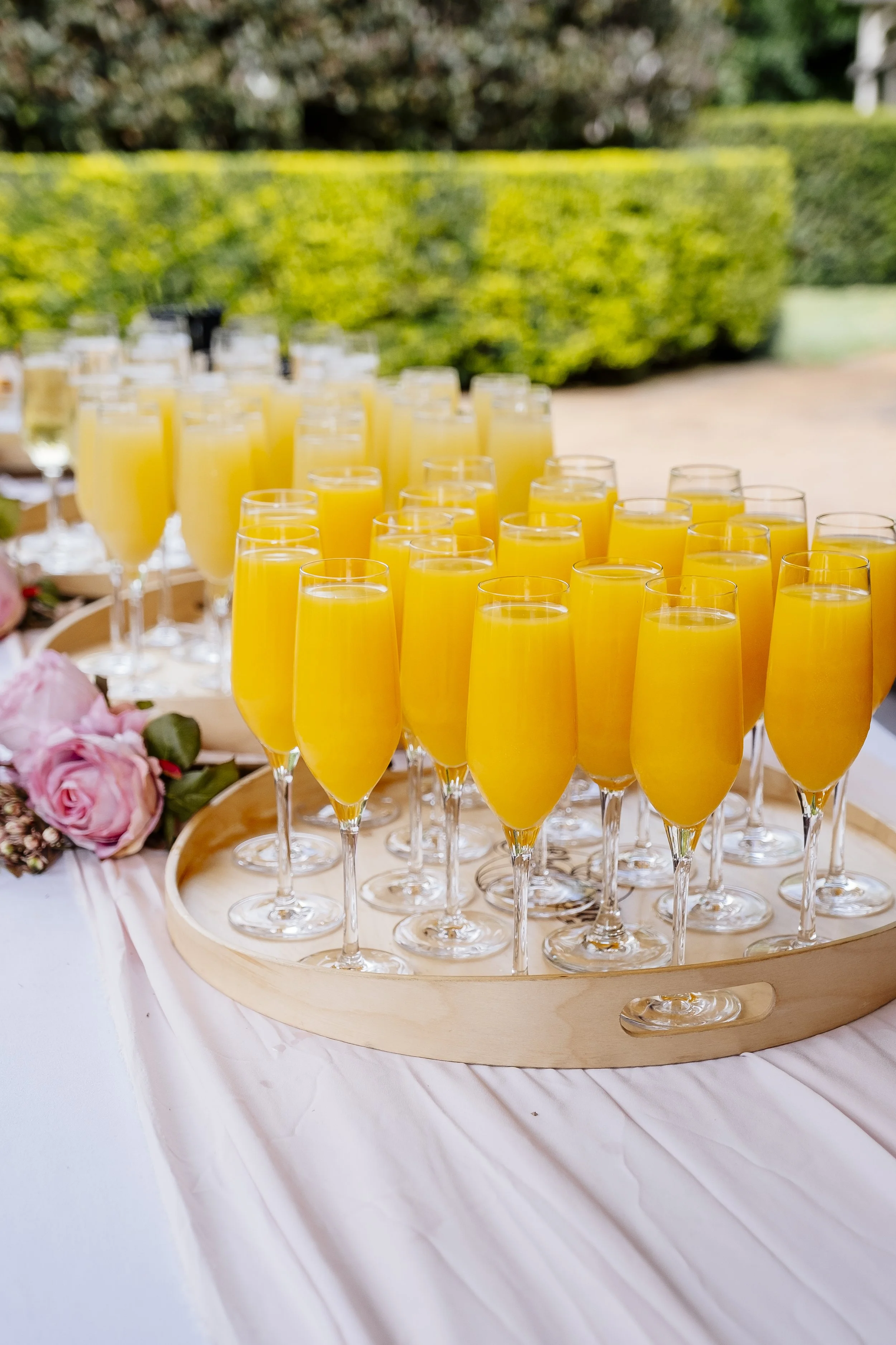 A tray of colourful welcome drinks prepared for wedding guests in the gardens at Shambala Estate.