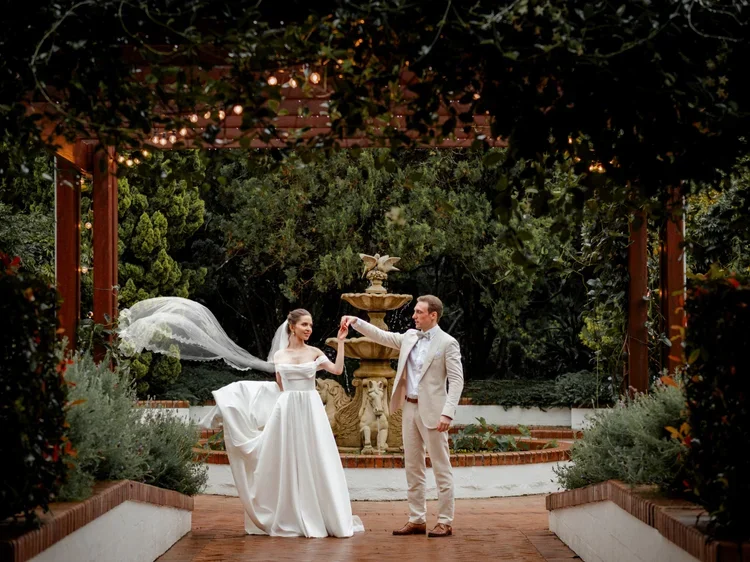 Couple celebrating beneath the garden pergola at Shambala Estate