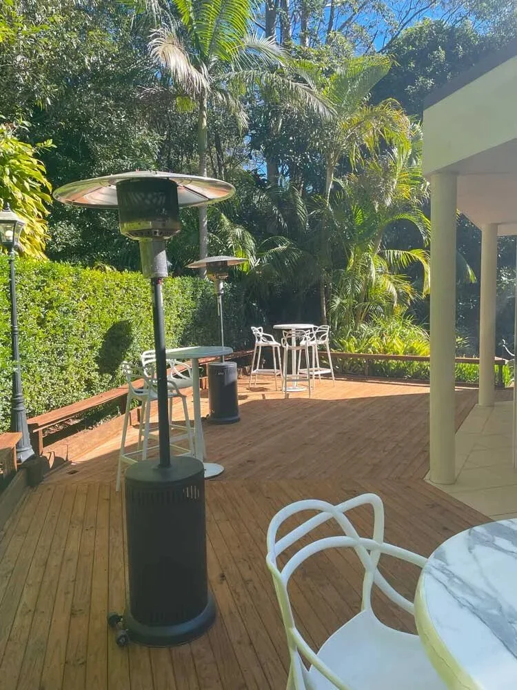 Covered deck and guest seating beside Shambala Estate's rainforest gardens.