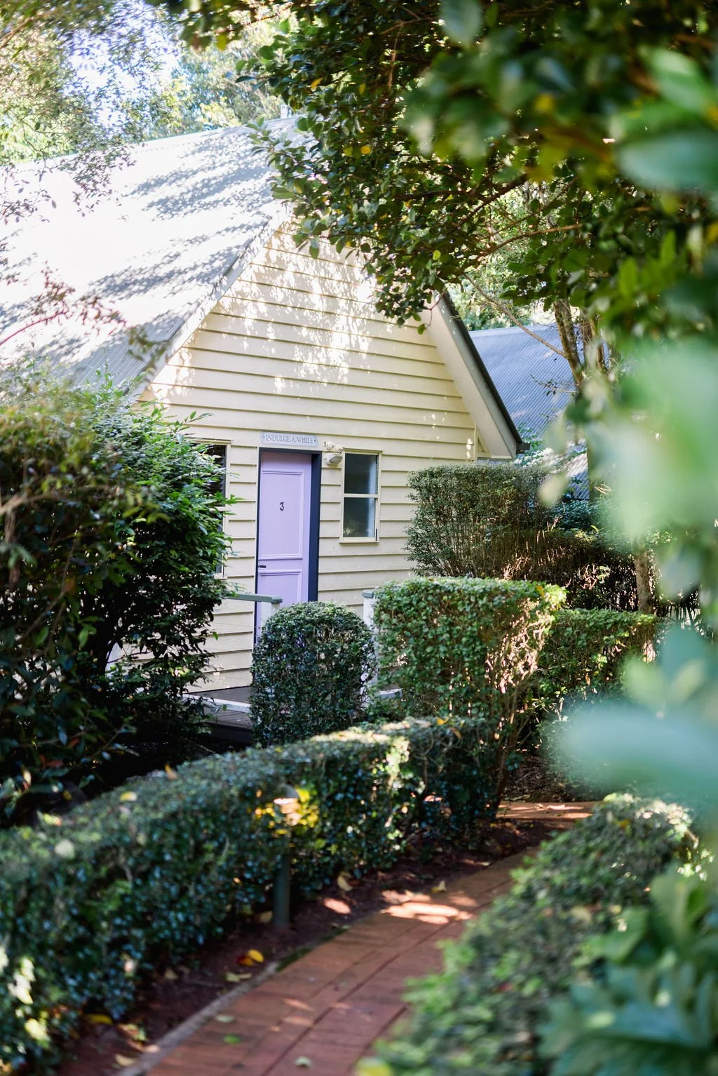 A Shambala Estate cottage among hedges and trees