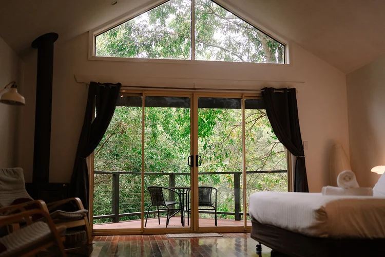 Private Shambala Estate cottage bedroom with fireplace and garden balcony