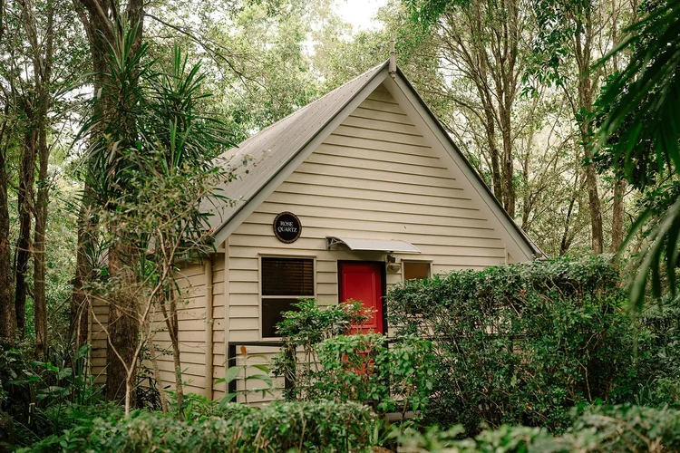 Rose Quartz cottage among the trees at Shambala Estate
