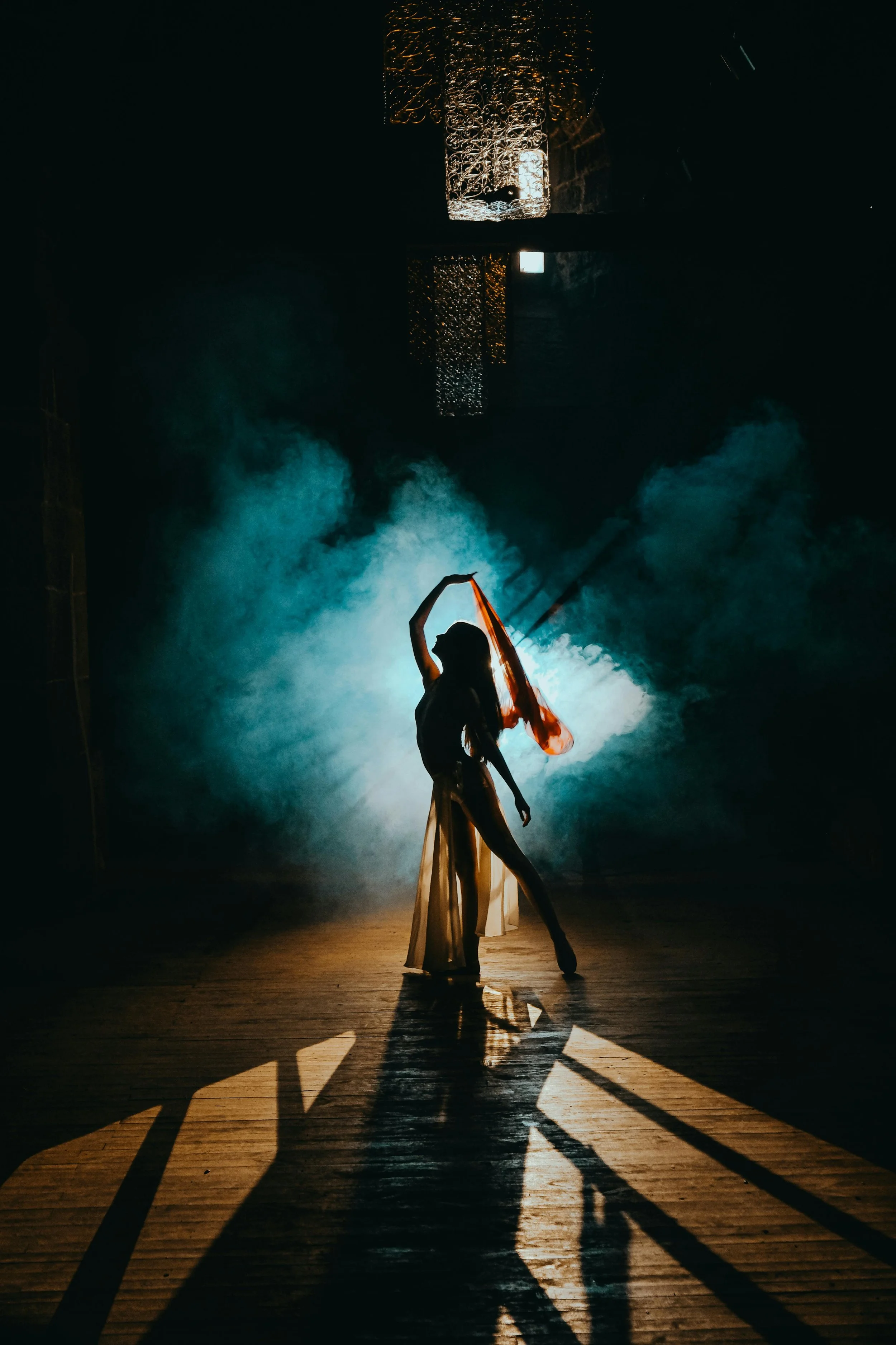 Silhouette of a dancer on stage in a musical theatre production