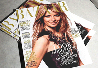 Stack of Harper's Bazaar magazines with a model on the cover, featuring the headline 'Look Gorgeous'.