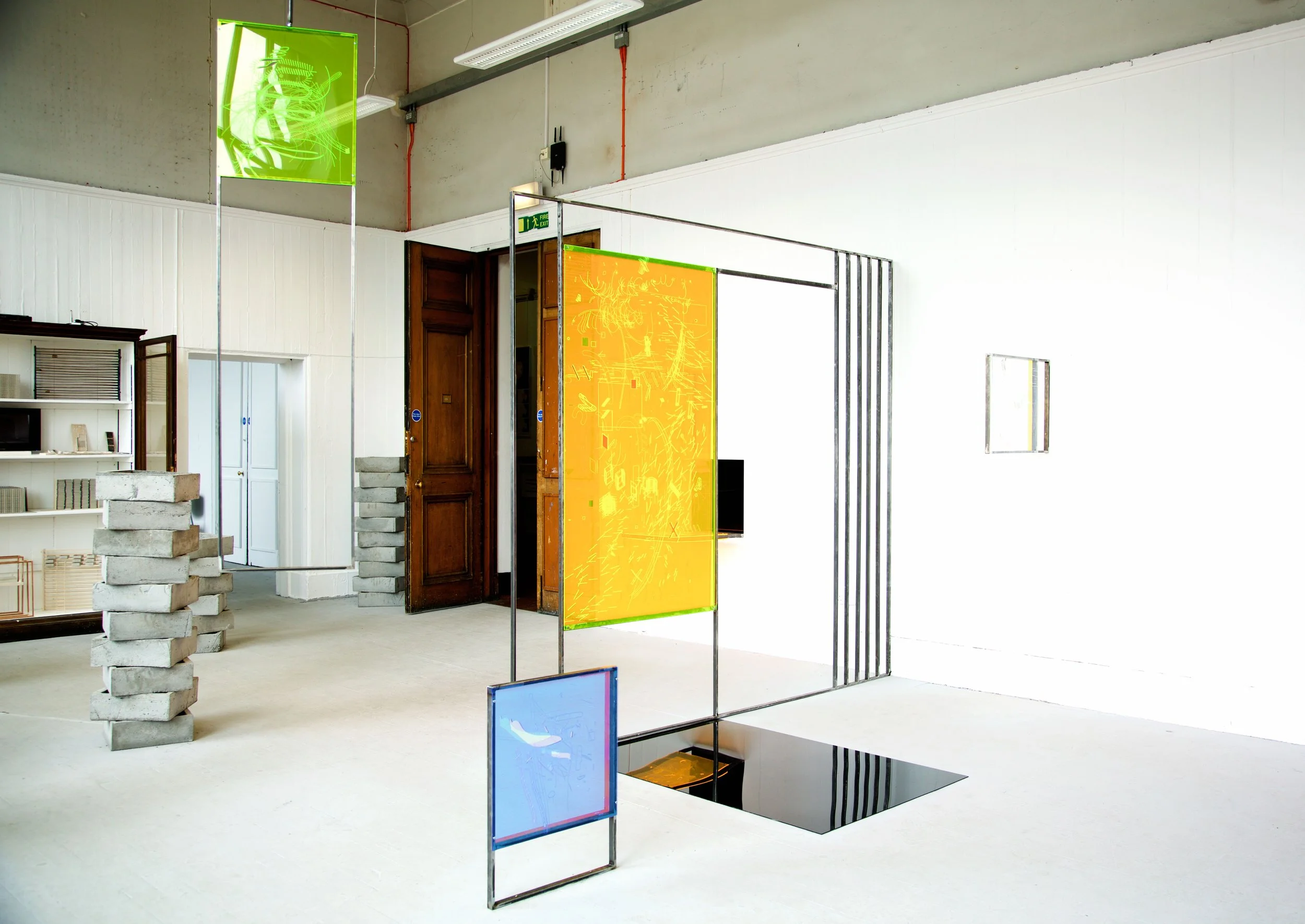 Art installation with colored panels in an industrial-style room.