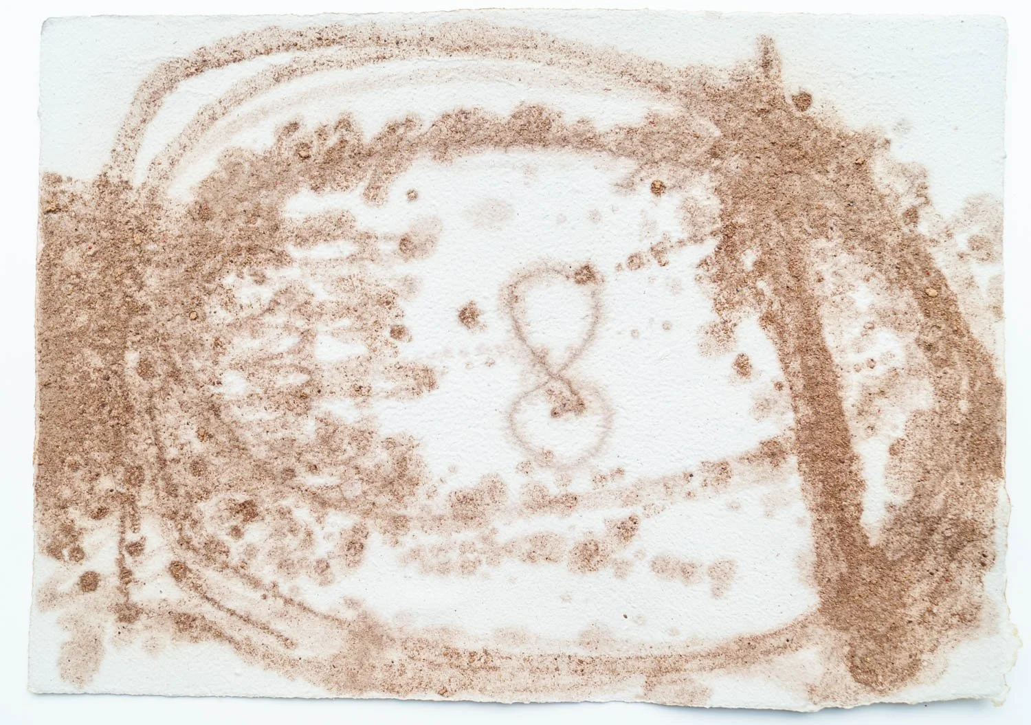 A cup of coffee with a latte art heart in the foam, surrounded by coffee beans.